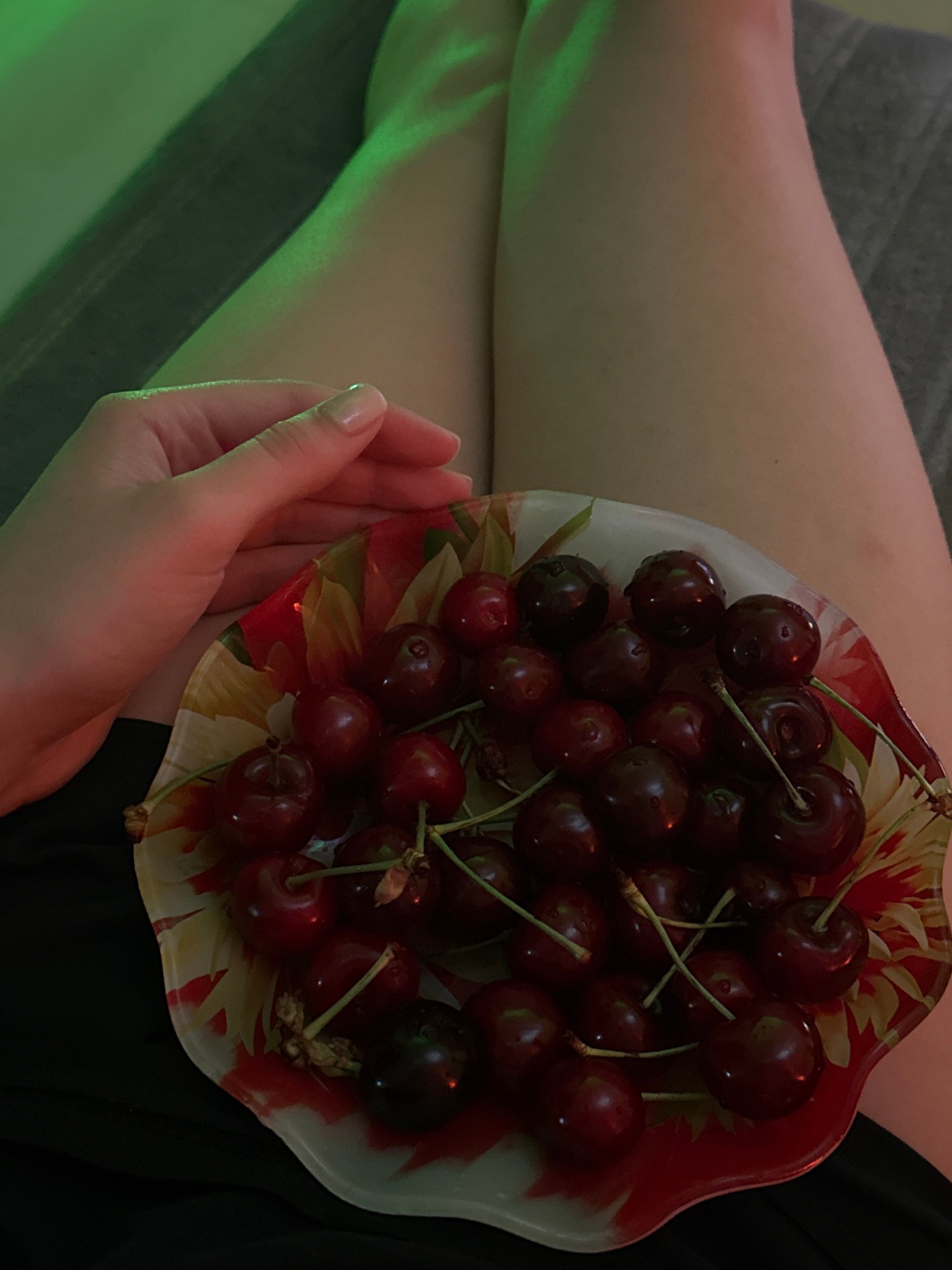 Evening snack session with cherries and soup under ambient lighting