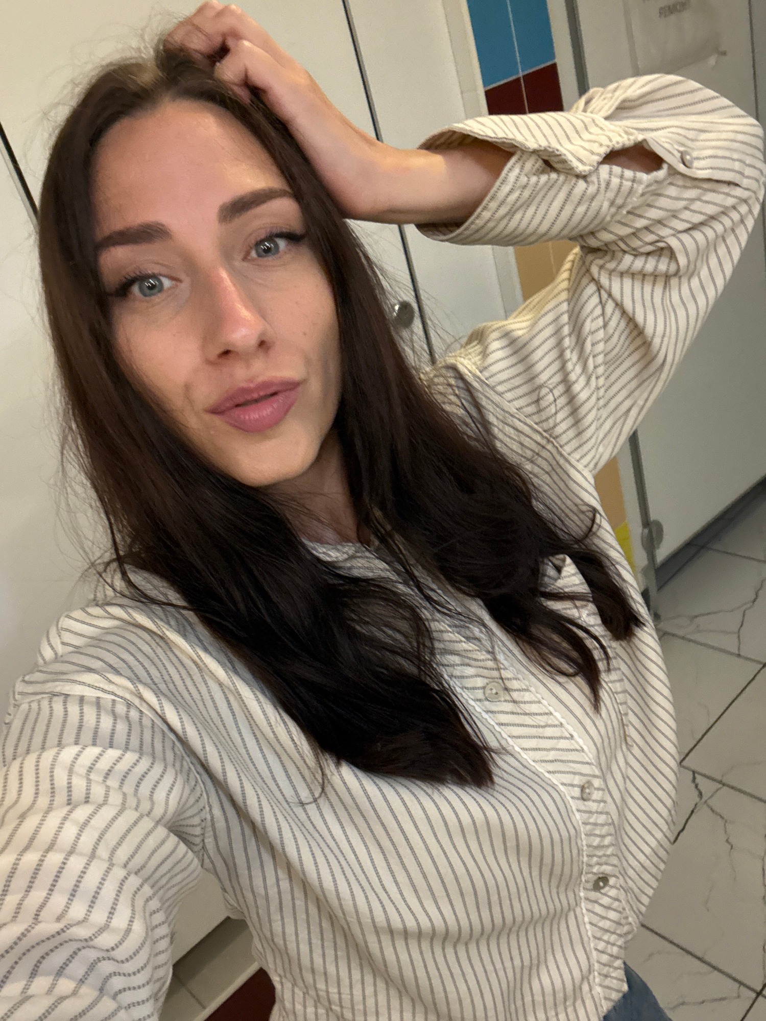 Back-to-back selfies in a locker room or restroom