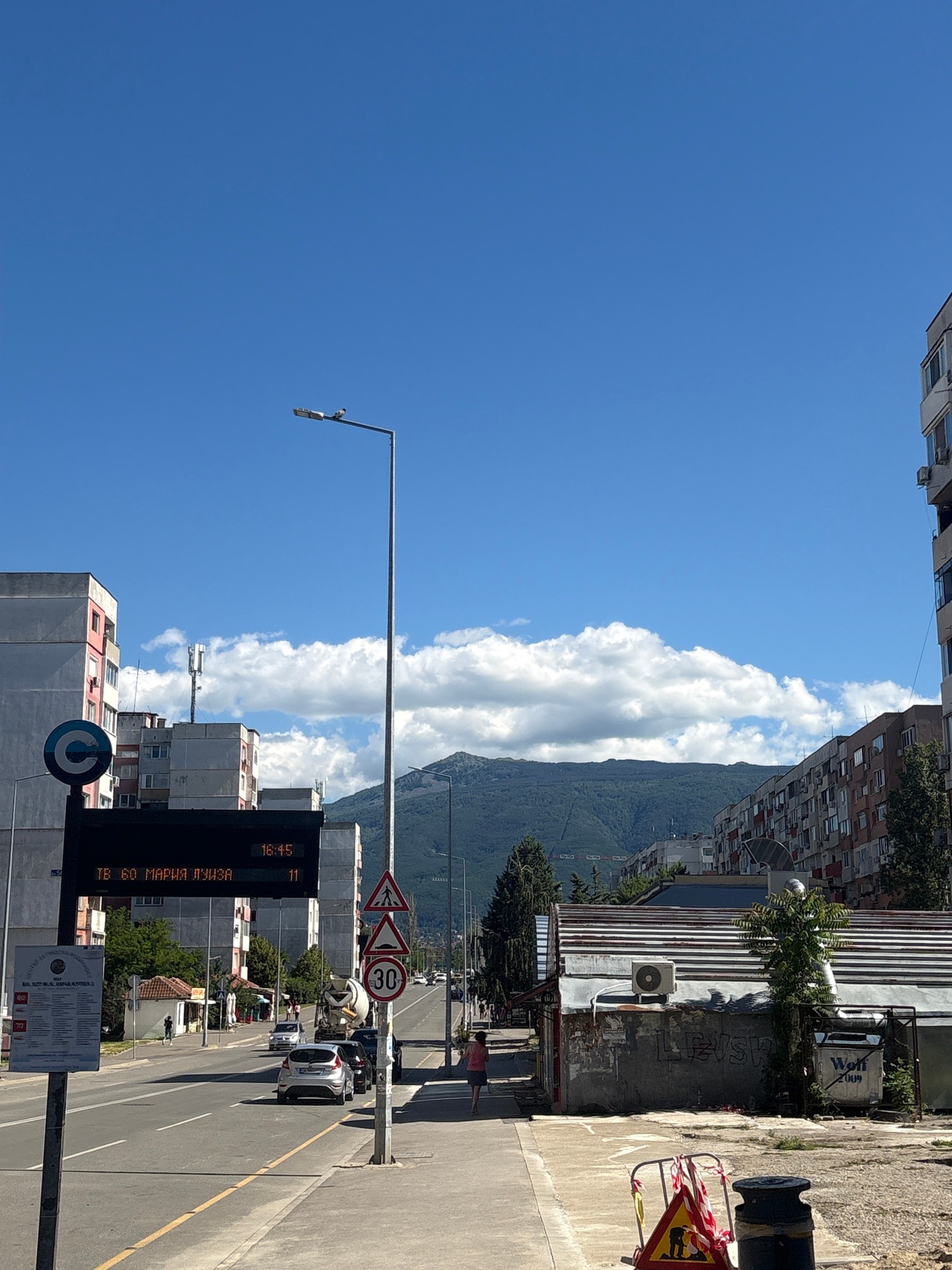 Urban neighborhood walk past construction sites and residential buildings