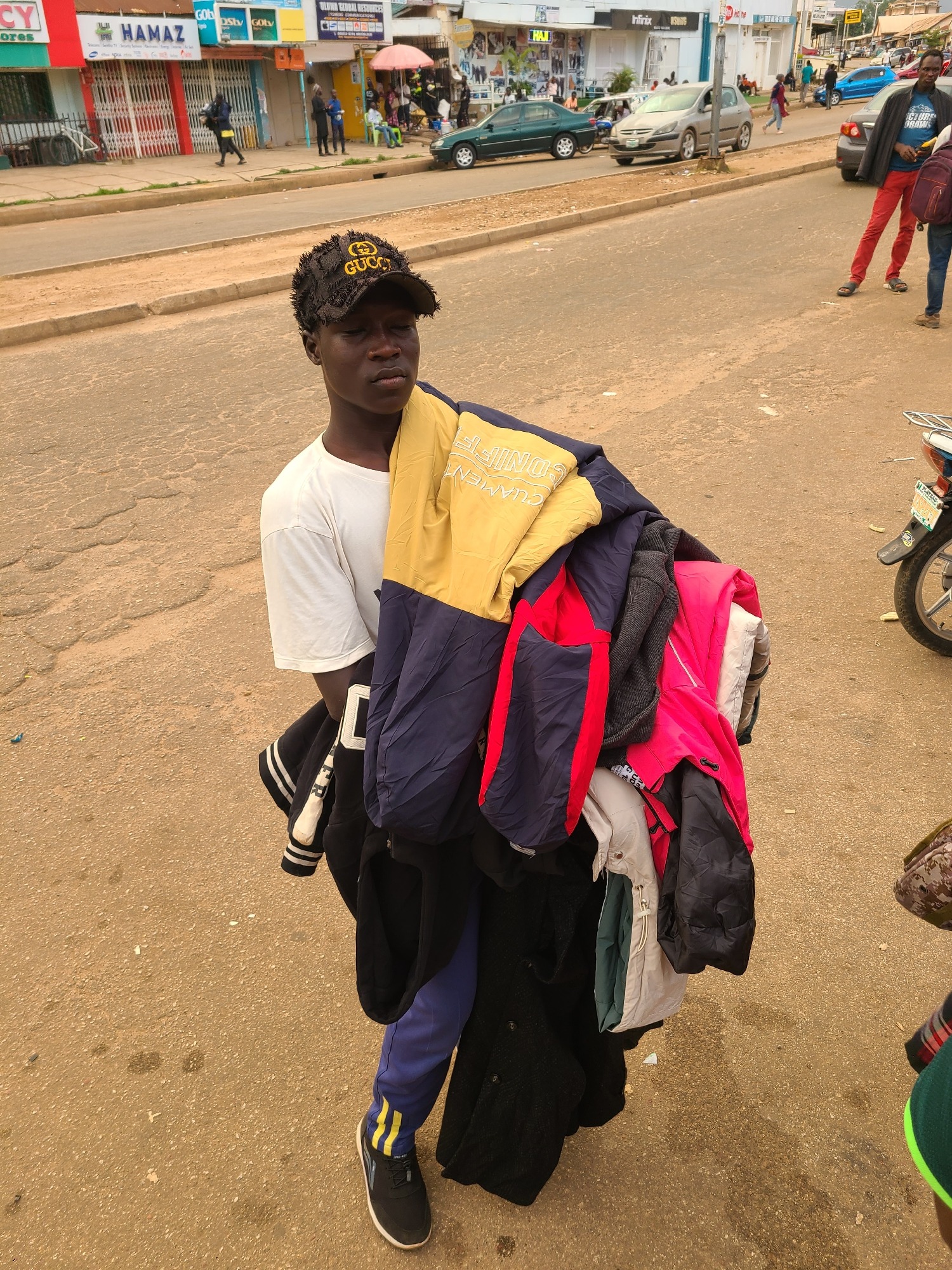 Street vendors and goods on a busy urban sidewalk