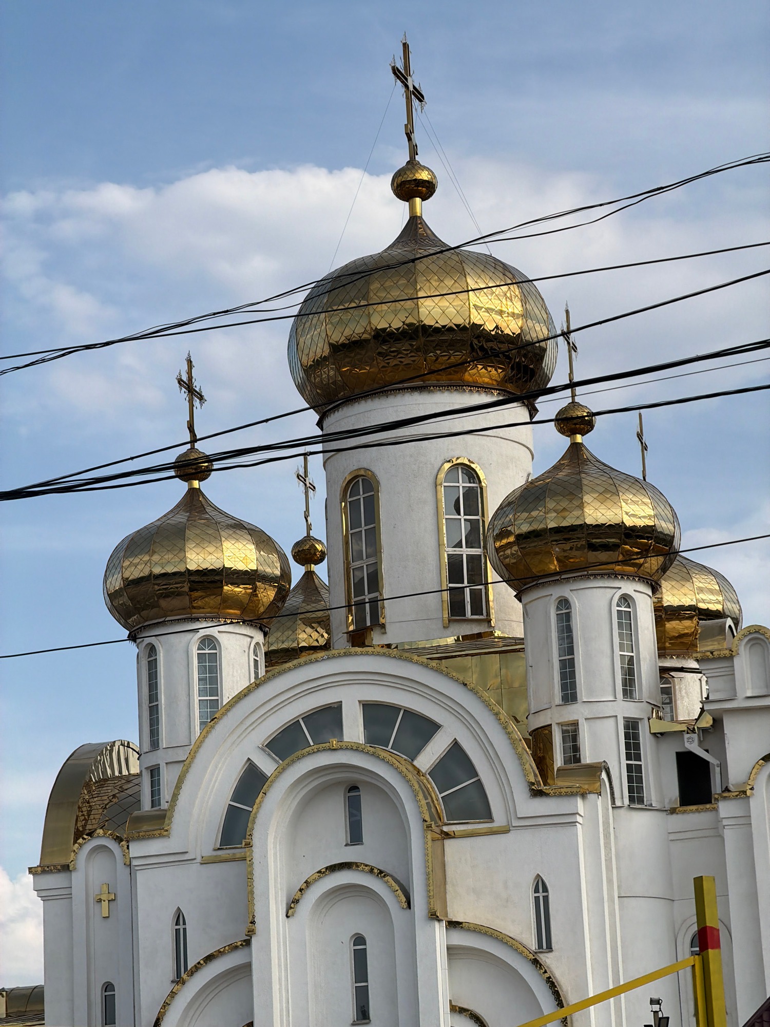 Orthodox church with golden domes in mountainous landscape