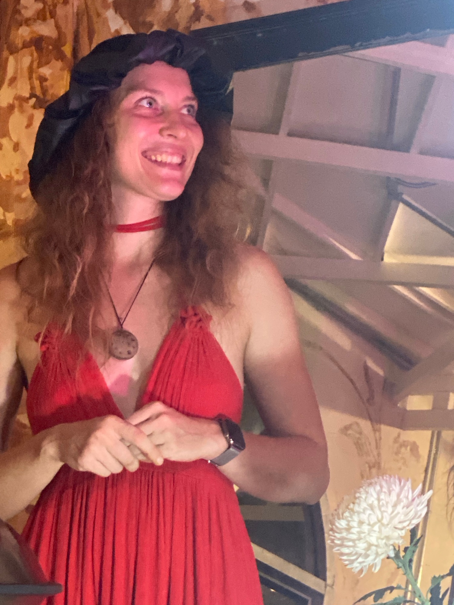 Live vocal performance in an eclectic, mural-filled indoor venue