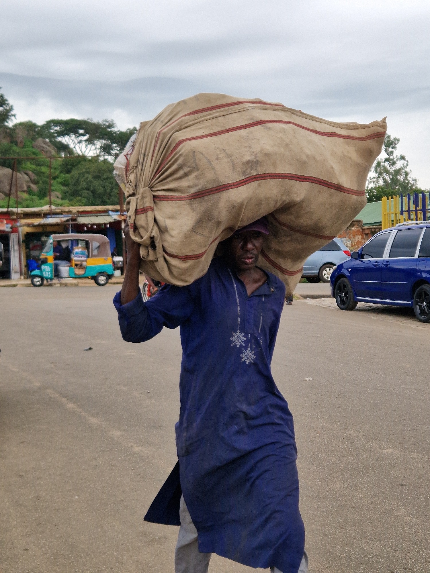Street vendors and pedestrians moving through a busy urban market