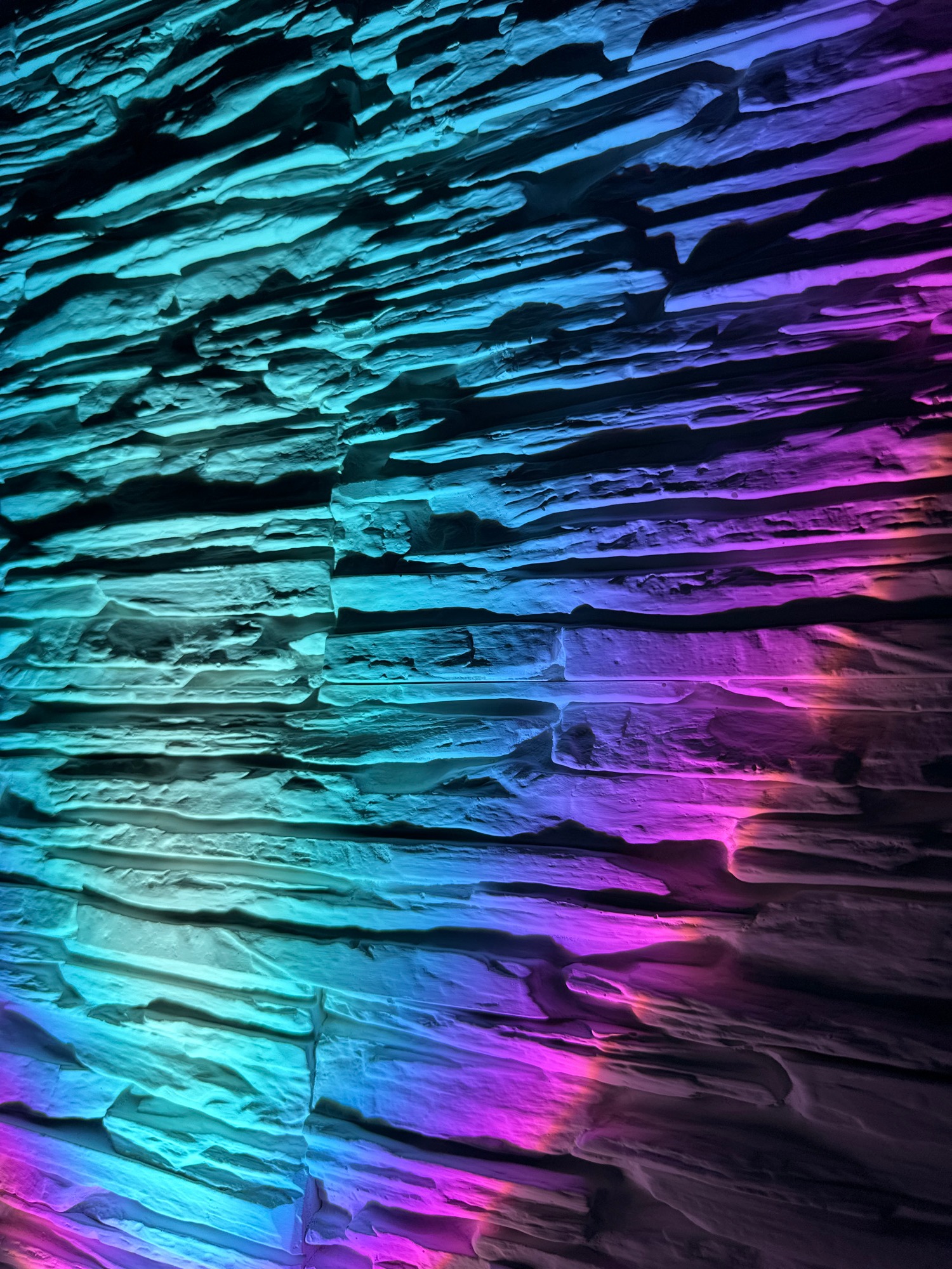 Textured surface illuminated by colored lights documented over five minutes