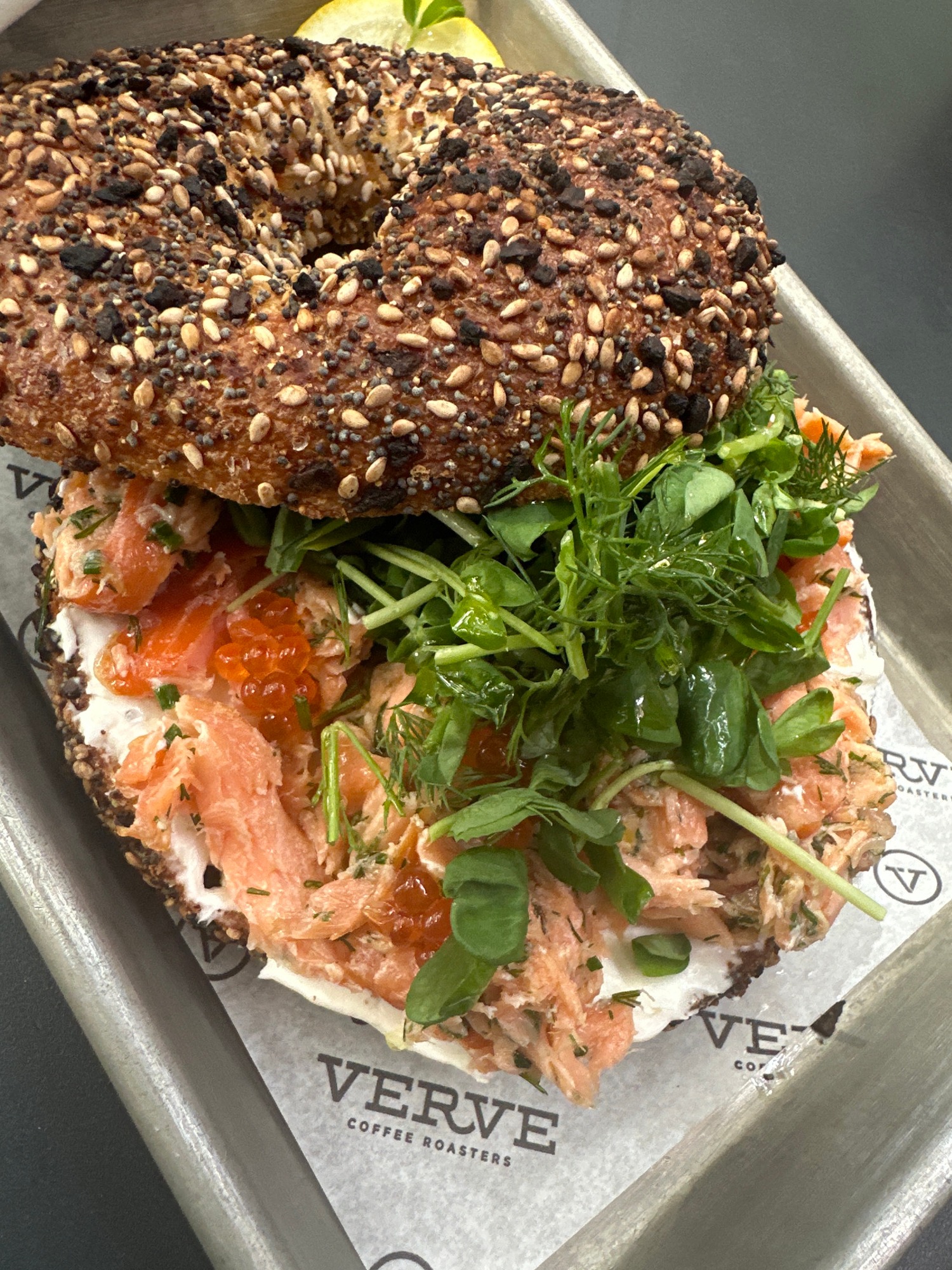 Gourmet seed bagel documented on metal tray