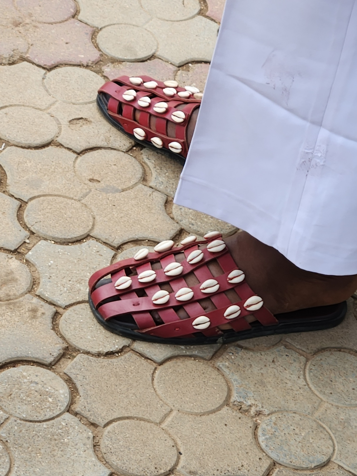 Woven sandals and an overloaded car on the move