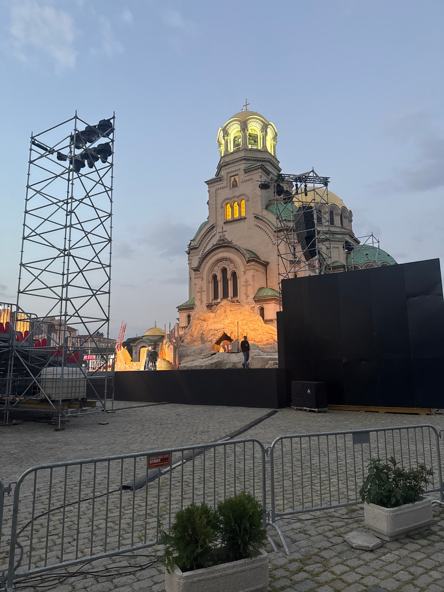 Golden-domed cathedral hosts event setup; beagle rides shotgun nearby