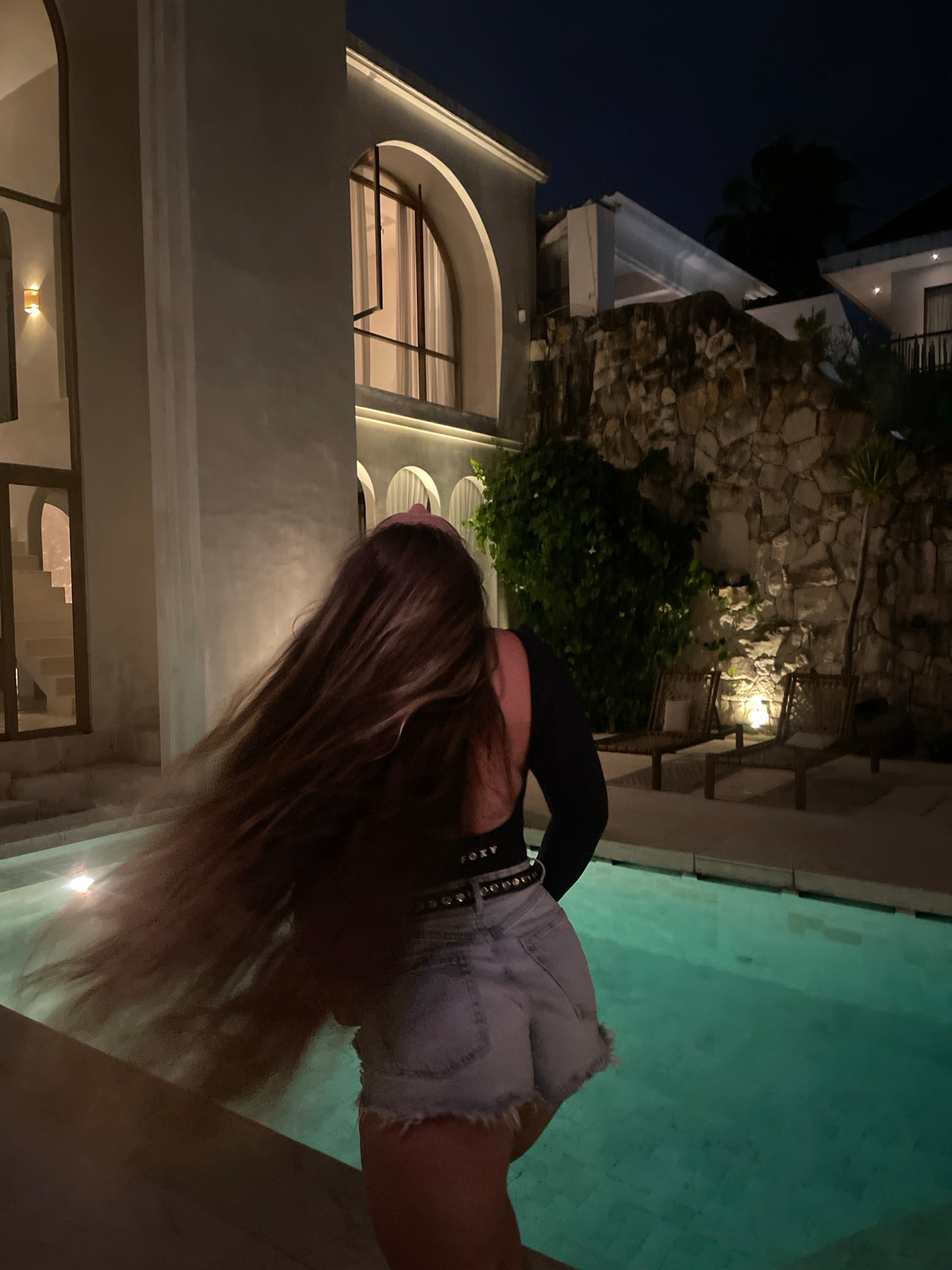 Night pool hang, black tops and denim, multiple poses.