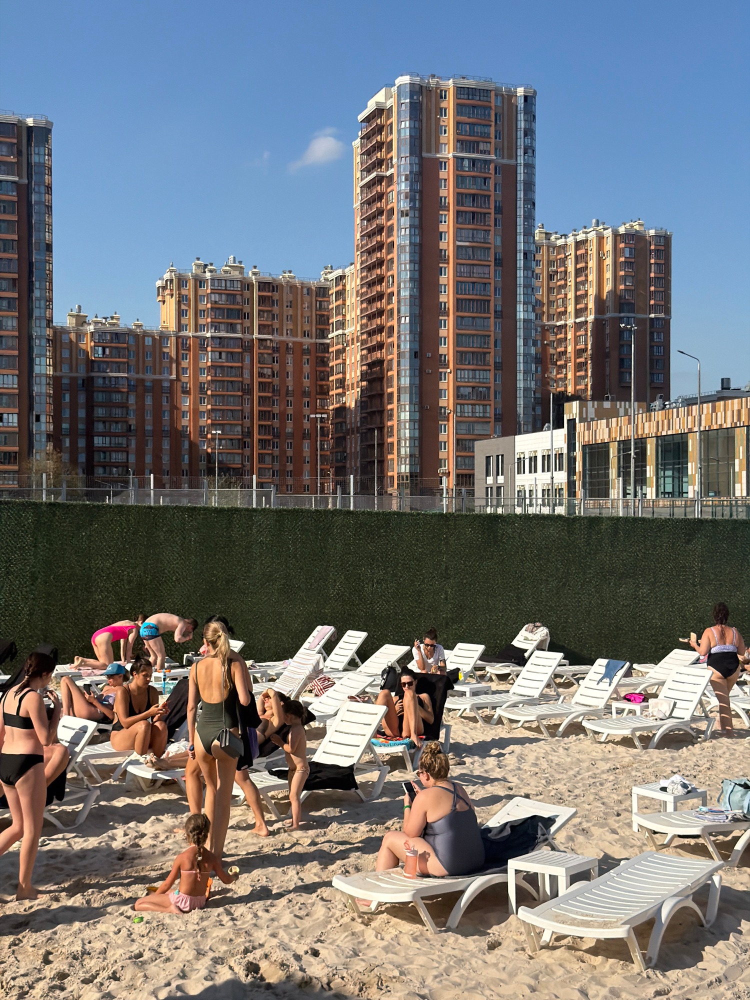 City high-rises backdrop a relaxed beach lounge scene