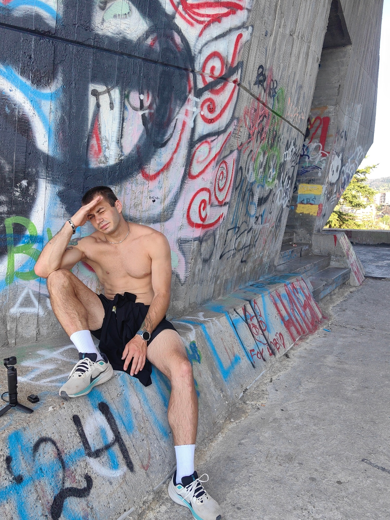 Shirtless poses and graffiti walls at an urban outdoor spot