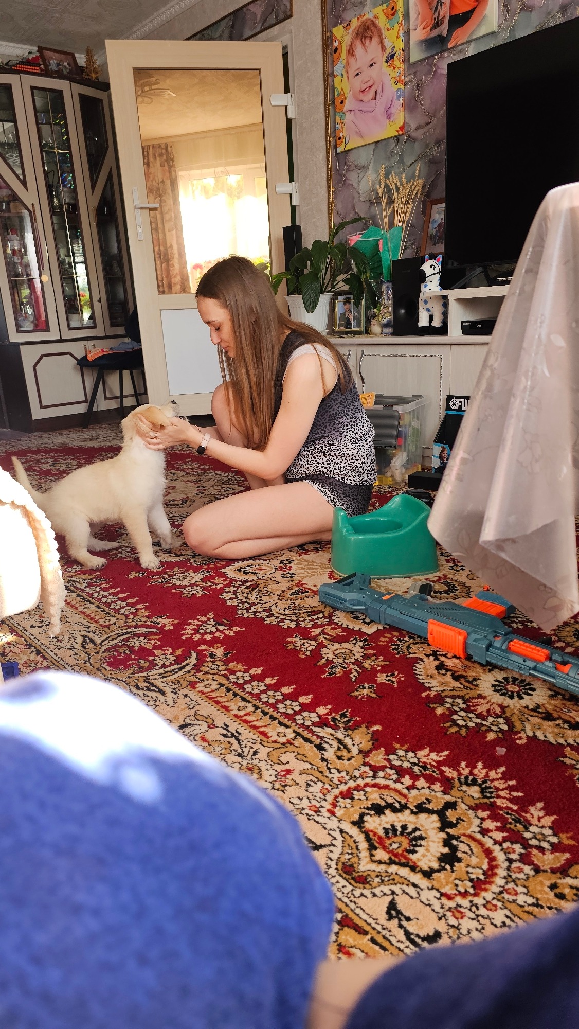 Playful Moments: Woman, Child, and Puppy Indoors