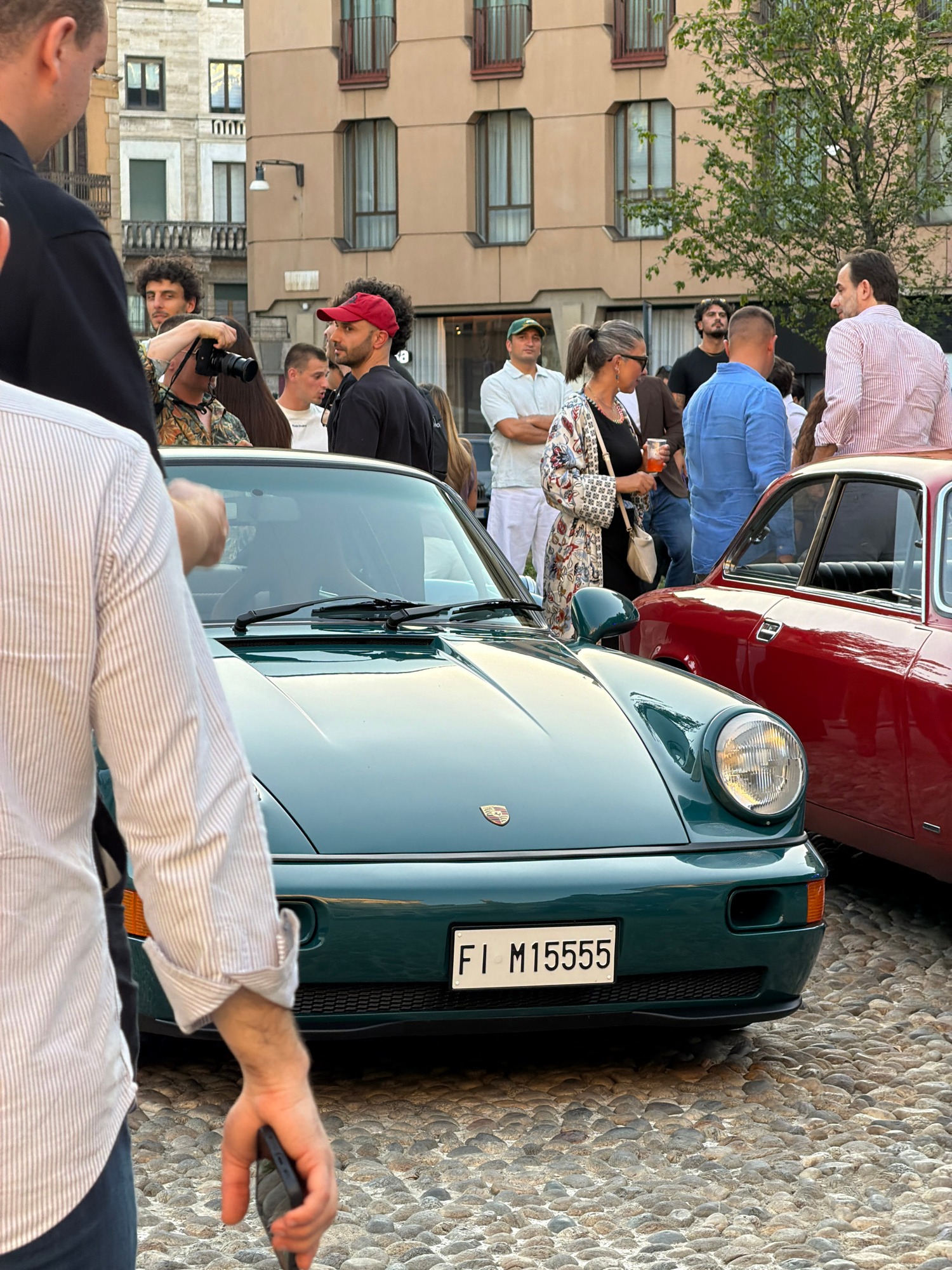 Vintage car meetup outside a European church with live DJ
