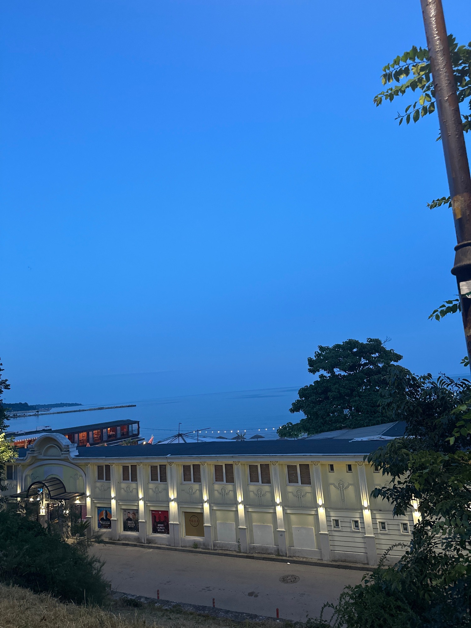 Dusk to night at a lively beachside waterfront venue