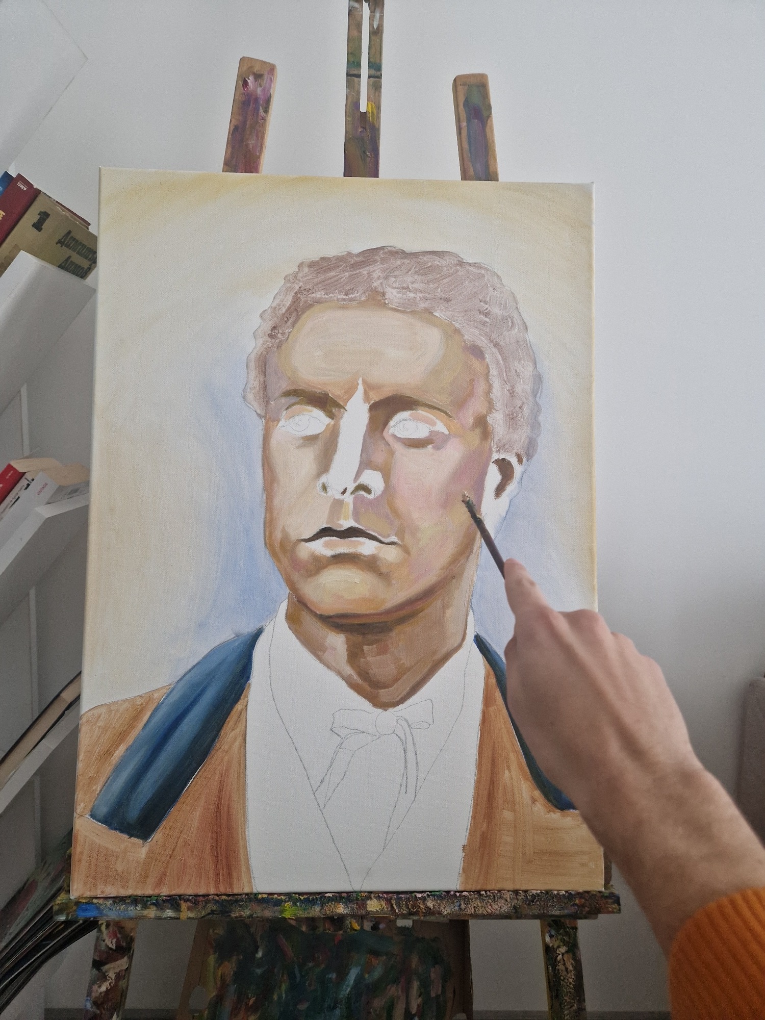 Artist paints male portrait on canvas early morning