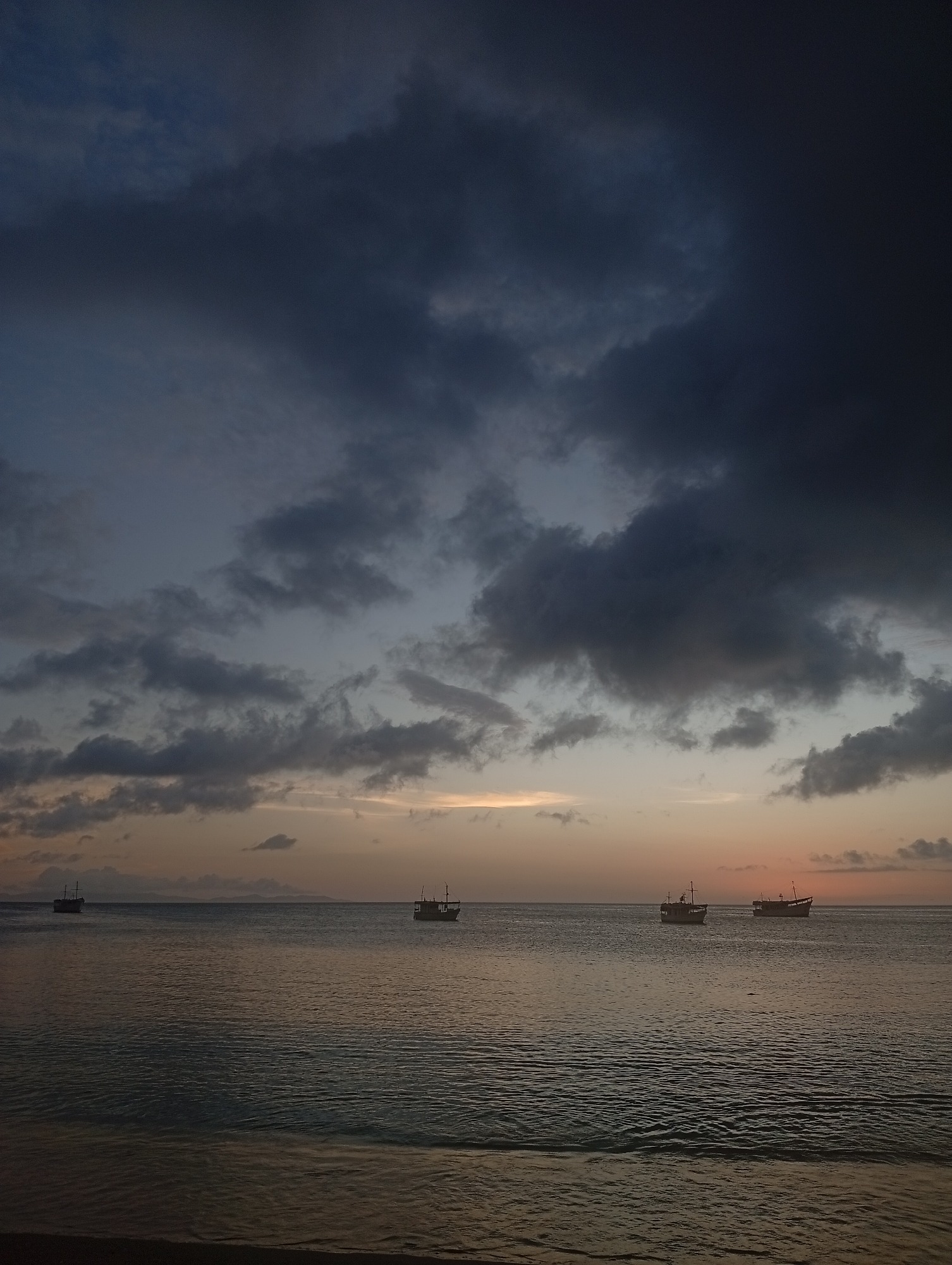 Sunset at the beach, boats on water, casual evening vibes