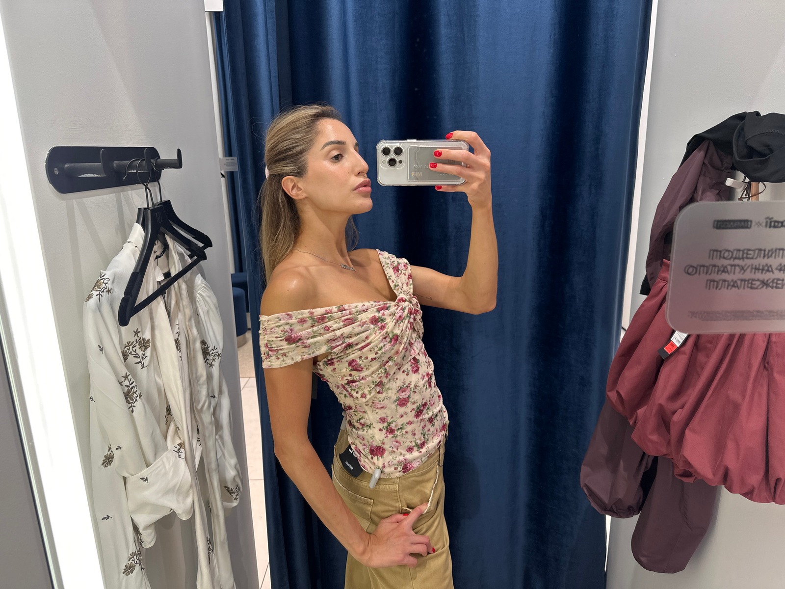 Fitting room try-on session with floral prints and mules