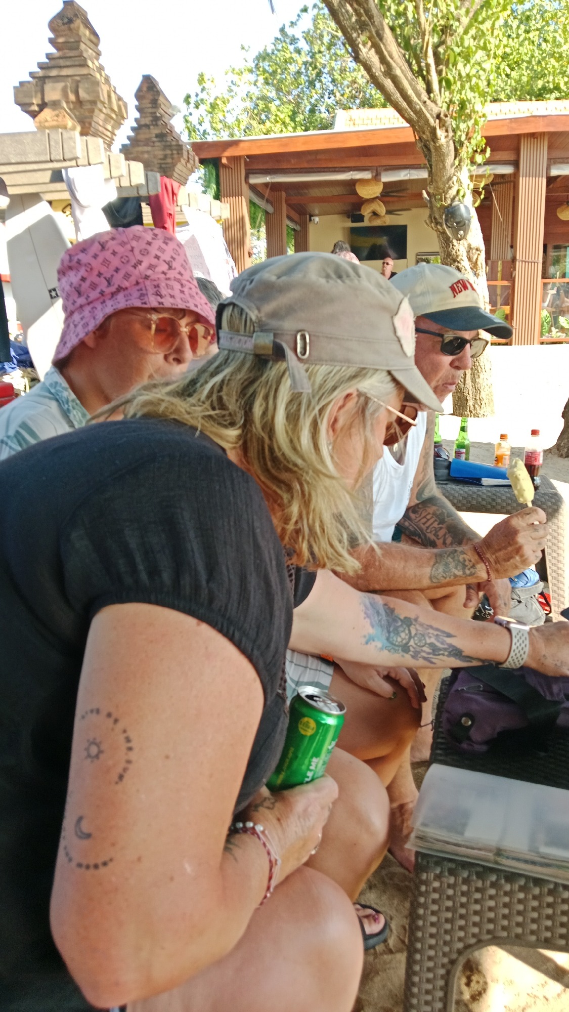 Lazy beach morning: surf rentals, corn vendors, and lounge chairs
