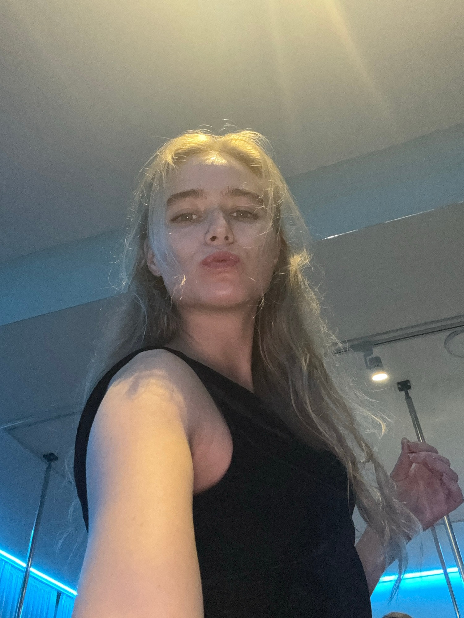 Woman documents workout session with multiple selfies in studio
