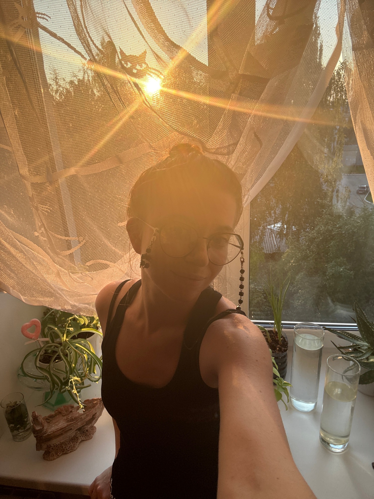 Golden hour selfie session by a curtained window with a white cat
