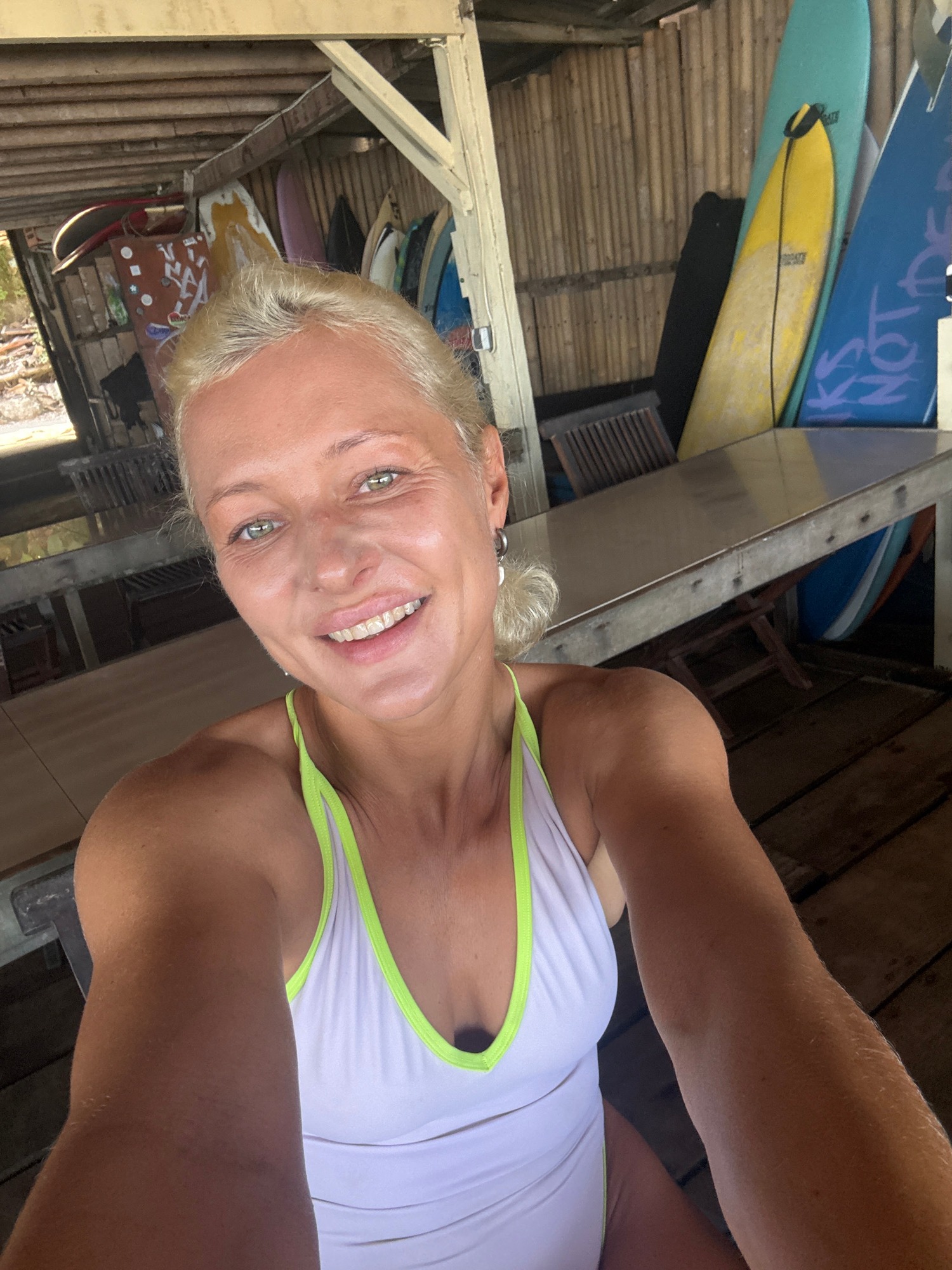 Woman takes late-night selfie at beachside cafe