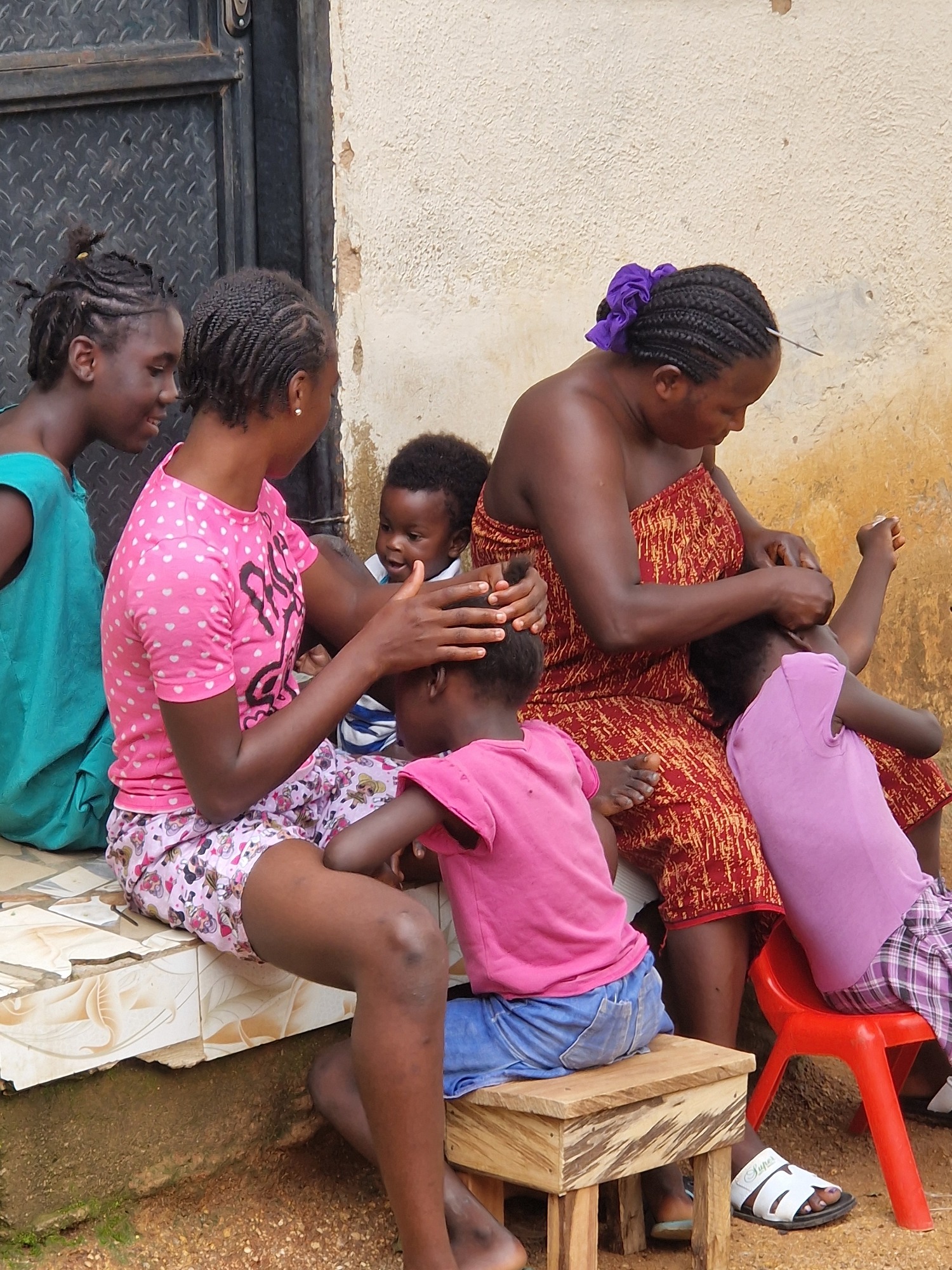 Everyday street life in a West African neighborhood, midday.