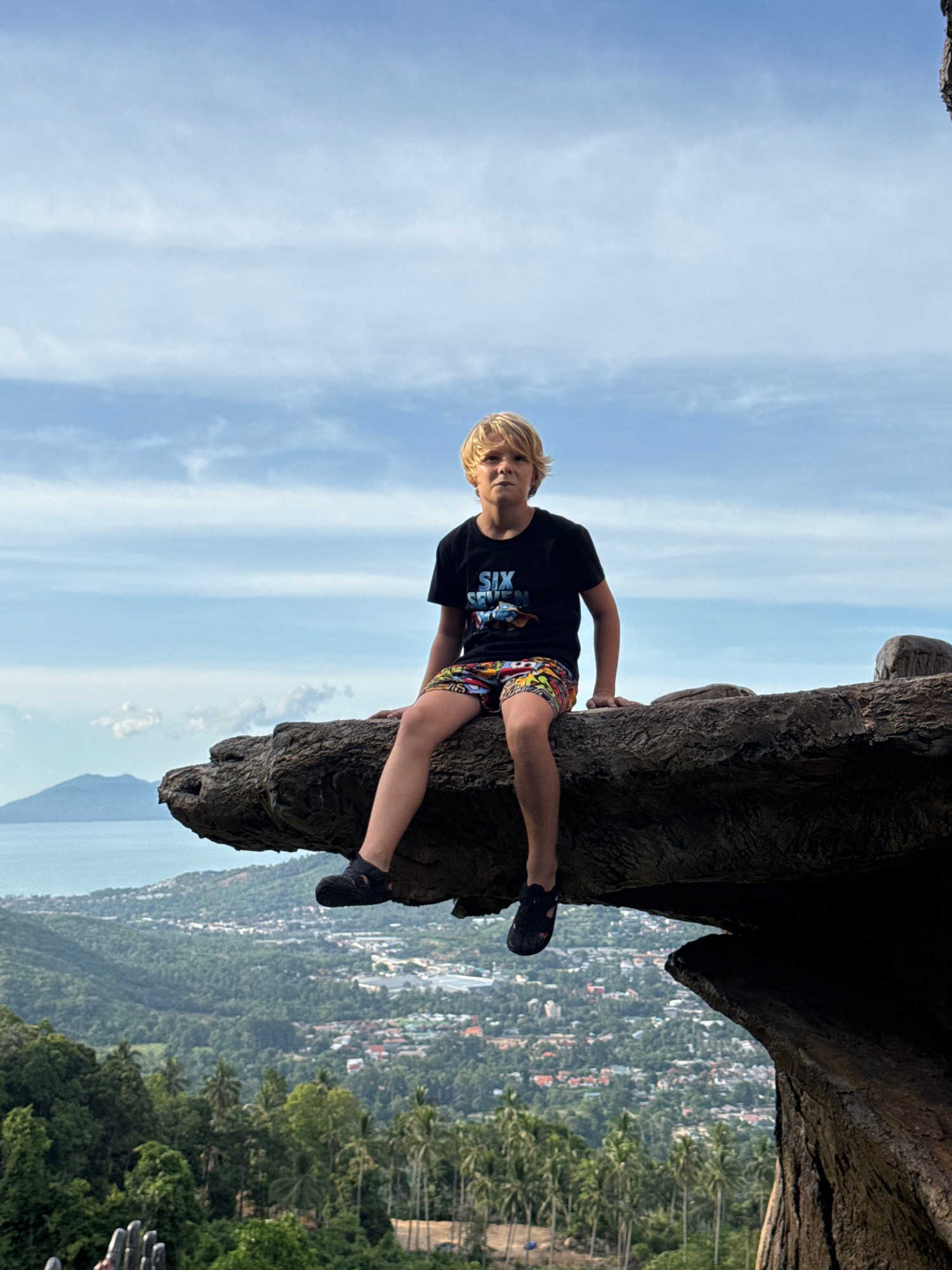 Coastal hilltop viewpoint with hand sculpture and ocean views