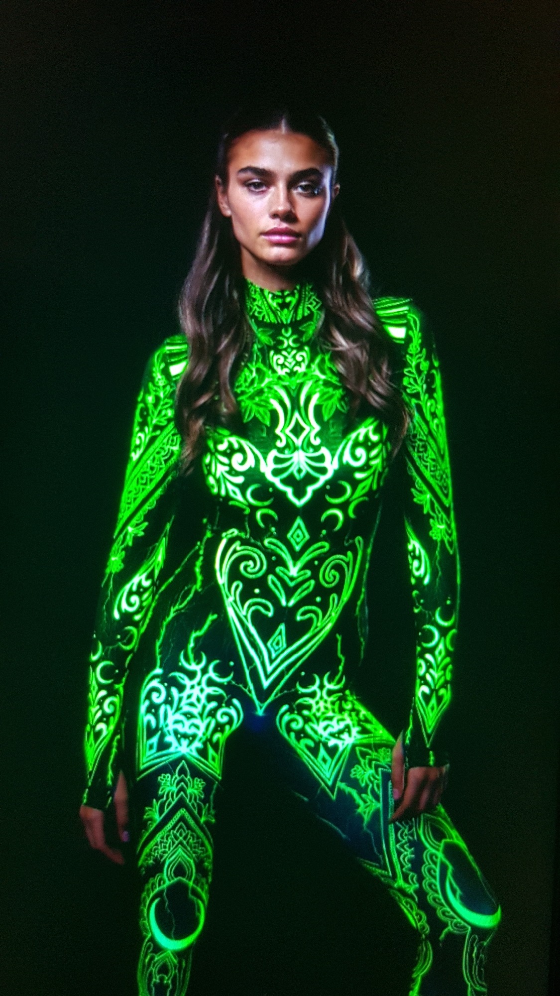 Glowing green body art and costume in a dark studio shoot