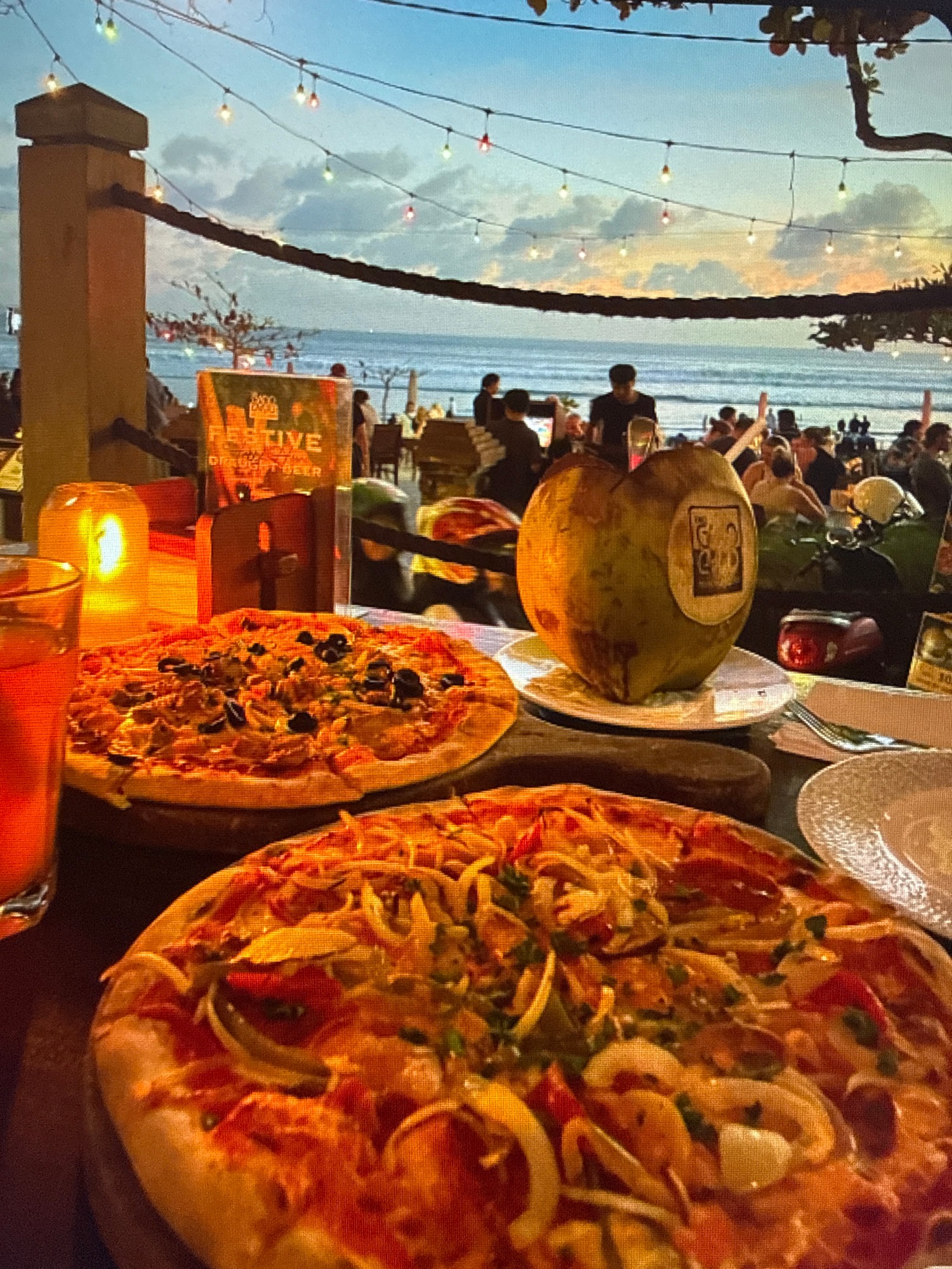 Beachside dinner evening with seafood, pizza, and coastal views