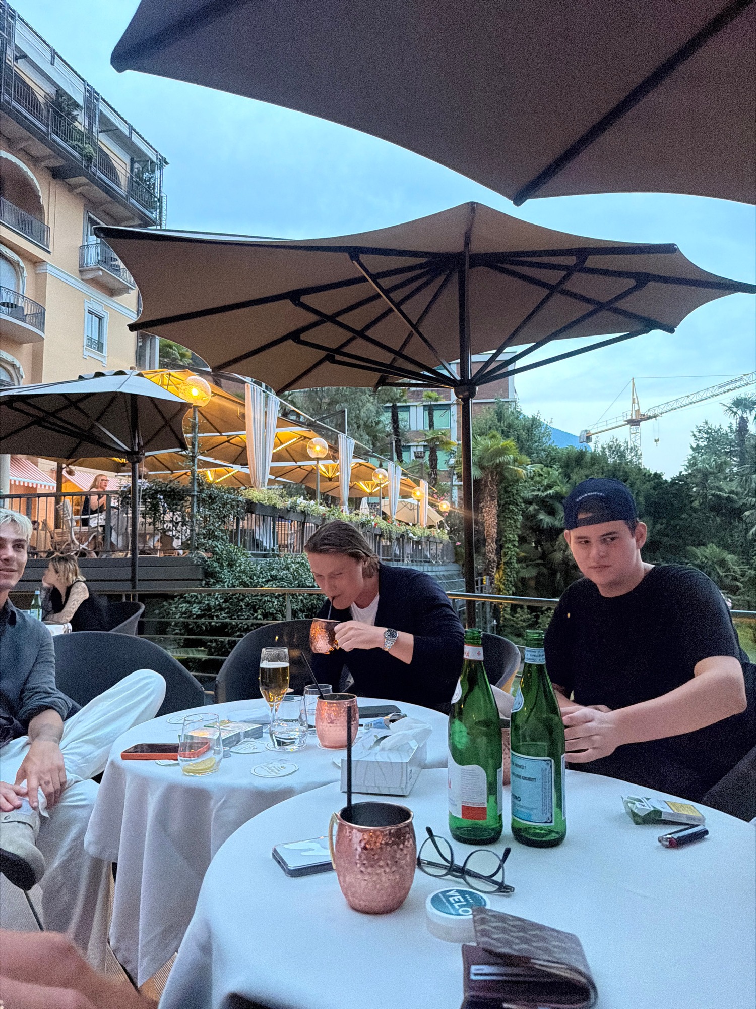 Dusk dinner on a hotel terrace with drinks and stew