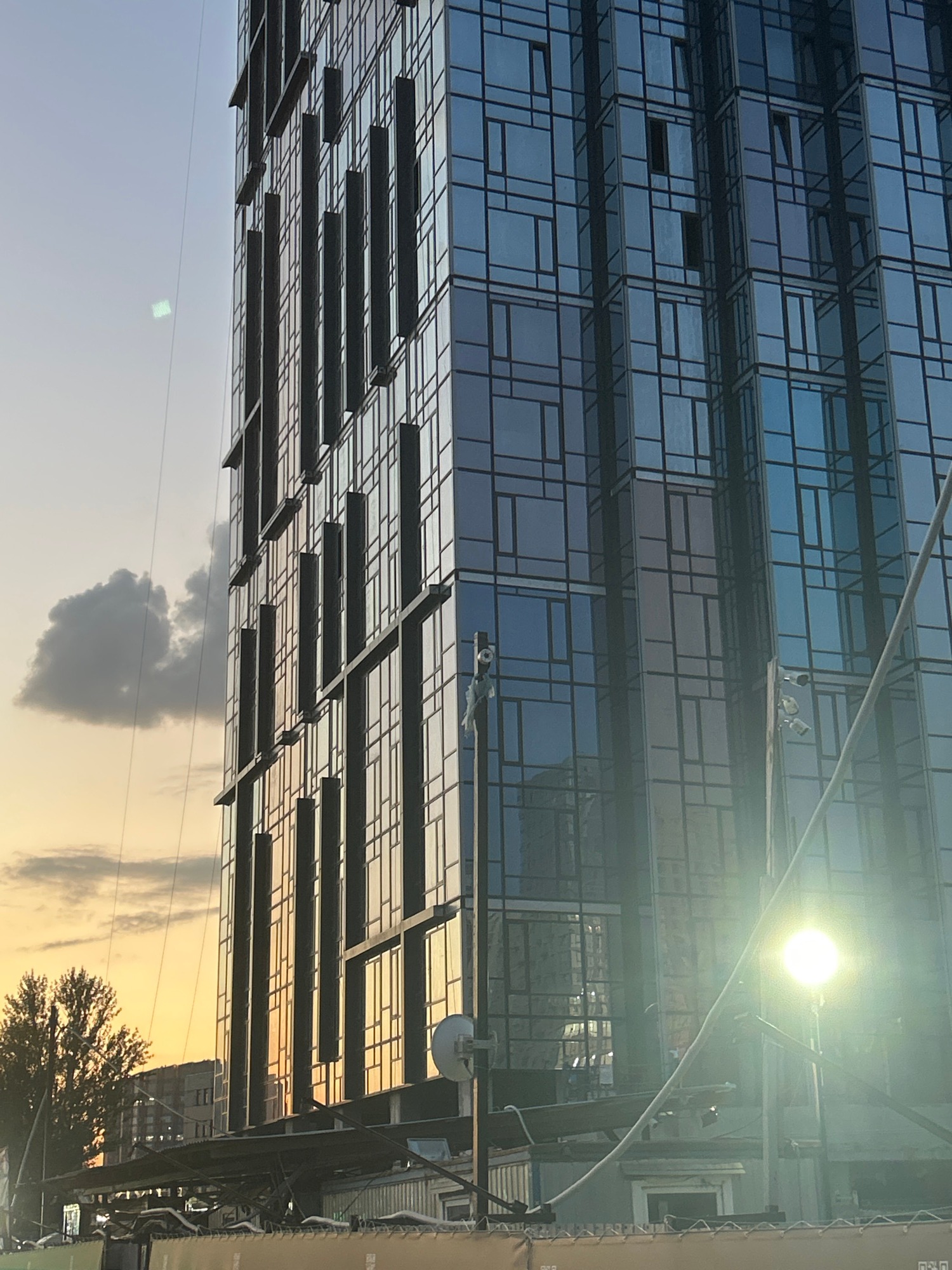 Glass tower and truss bridge at the edge of dusk