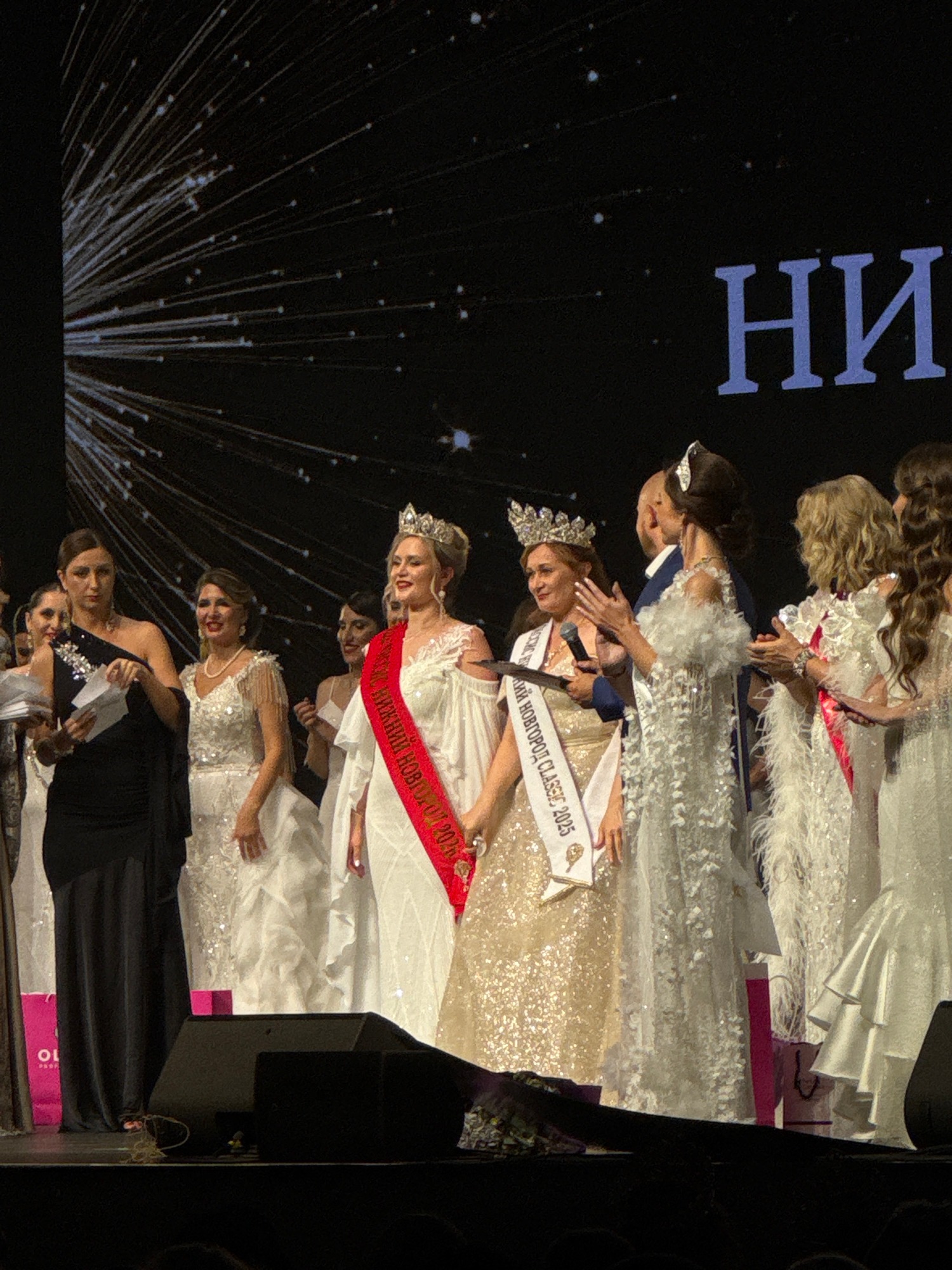 Beauty pageant contestants gather on stage for awards ceremony