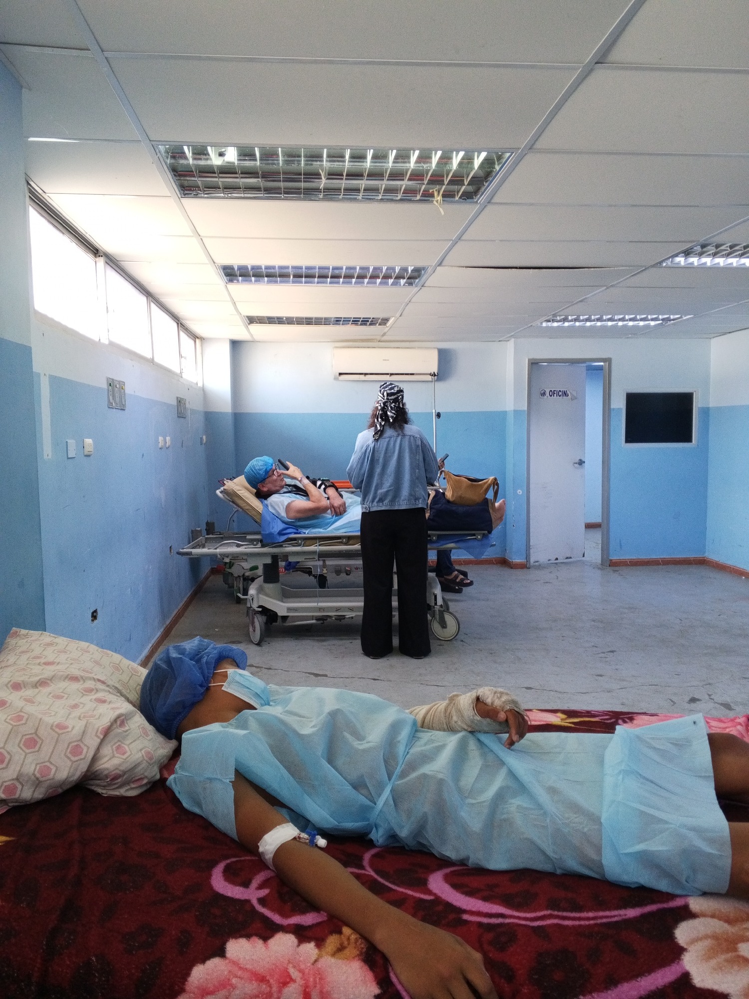 Hospital ward: multiple patients resting with bandages and IVs