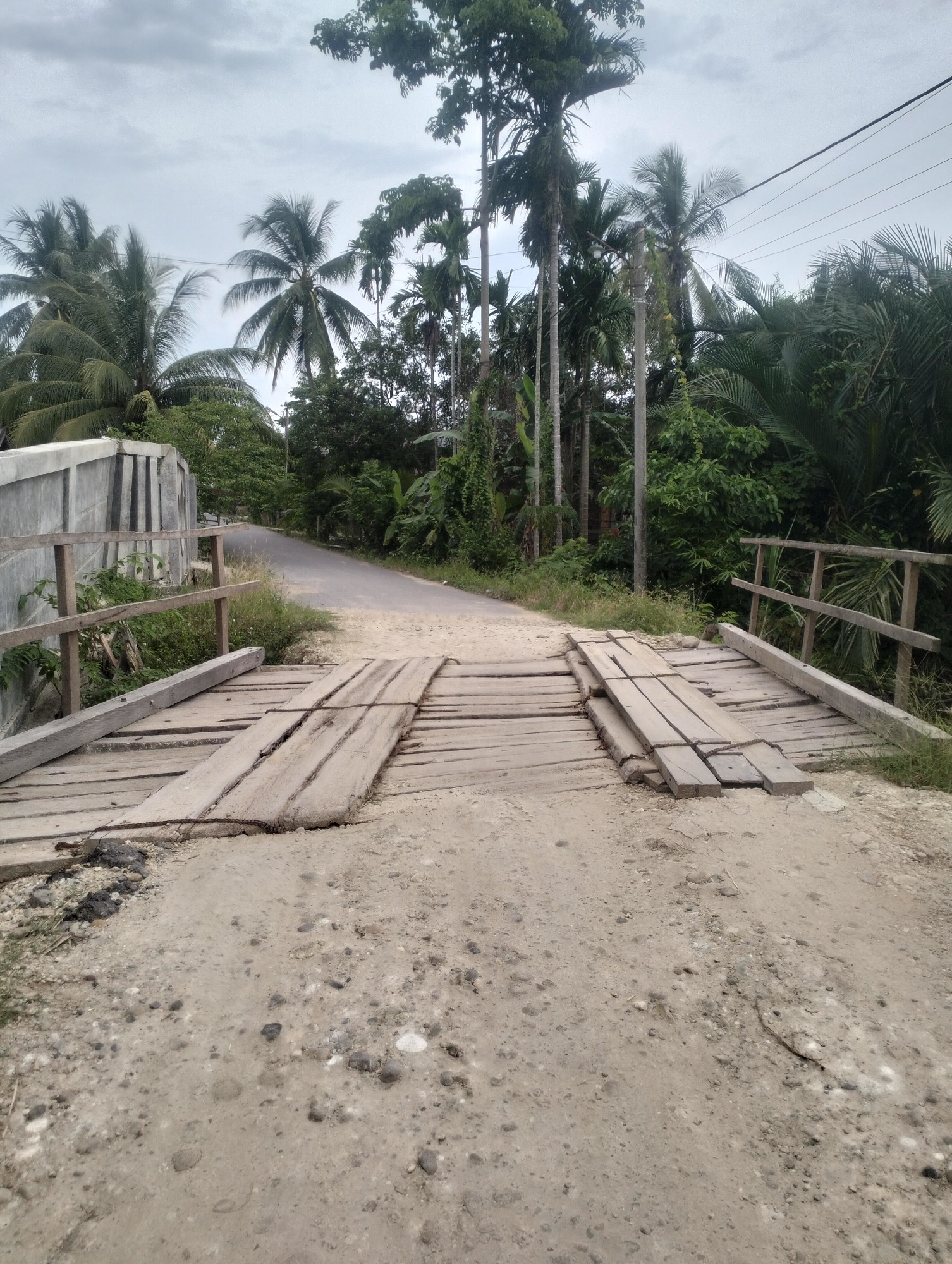 Quiet Indonesian village: mosque, welcome signs, and a volleyball game