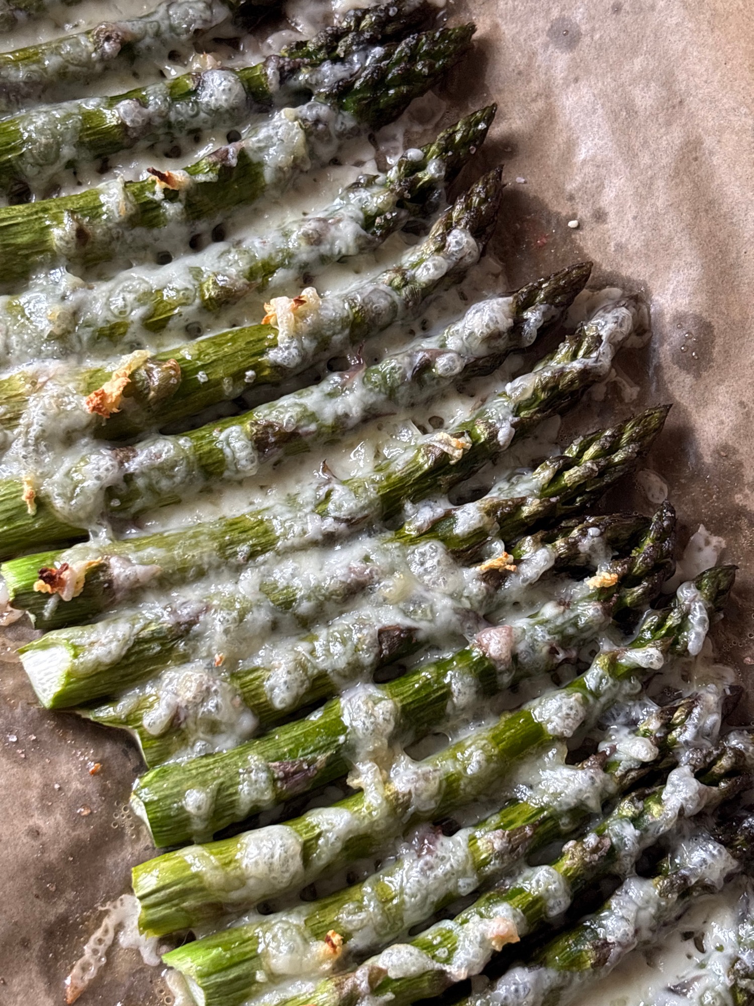 Baked asparagus with melted topping documented by witness