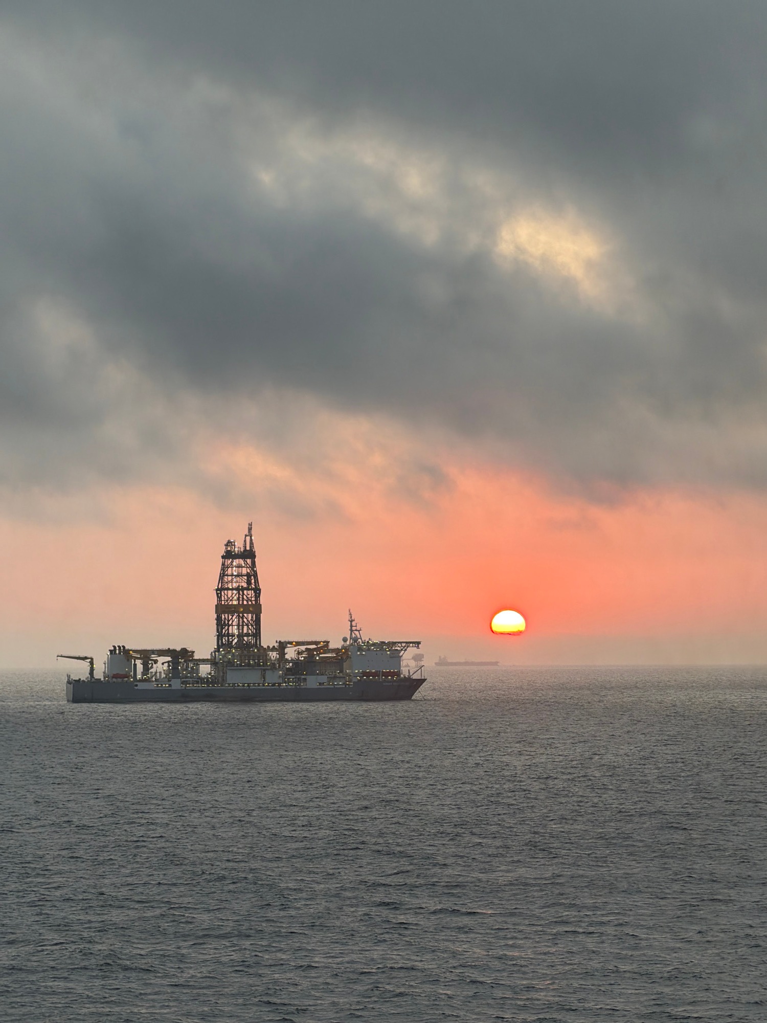 Offshore oil rigs observed during dramatic sunrise in Gulf