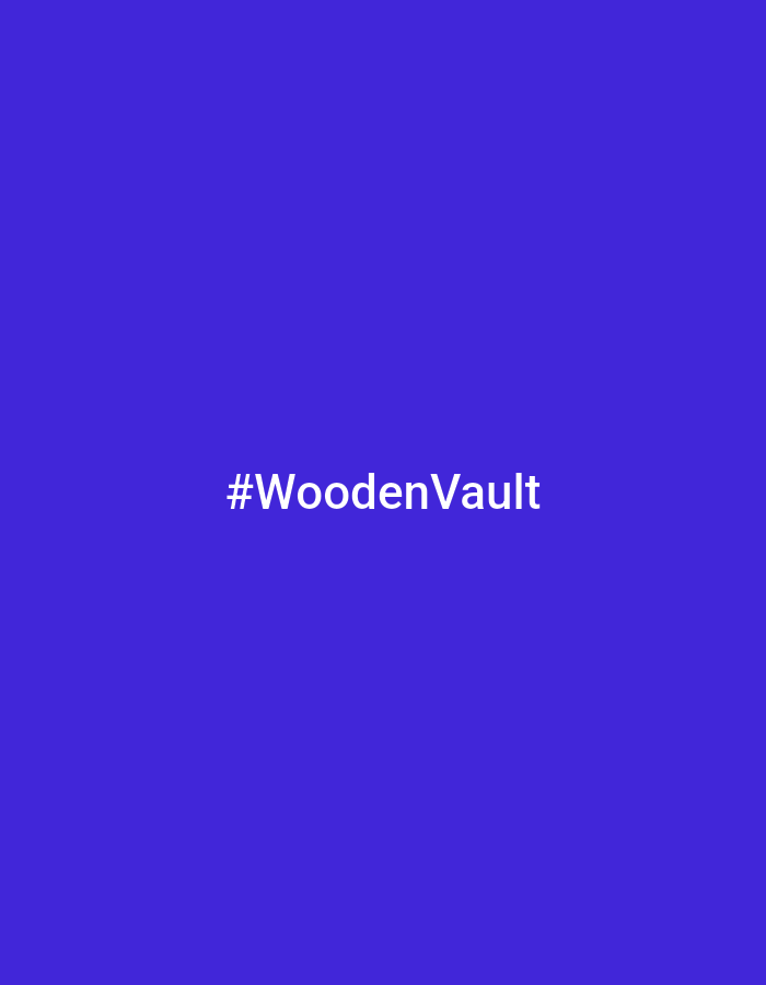 The image is a static graphic with a solid, vibrant purple background. Centered in the frame, written in white sans-serif text, is the hashtag "#WoodenVault". The text is clean and easily readable against the dark background. There are no people, objects, or environmental details depicted; the image is solely focused on the text against a monochromatic backdrop. The overall presentation is minimalist and graphic design-oriented, likely intended for social media or branding purposes. There are no discernible cues about the time of day, weather, or specific location beyond the textual content. The emotion conveyed is neutral due to the absence of any figurative elements.