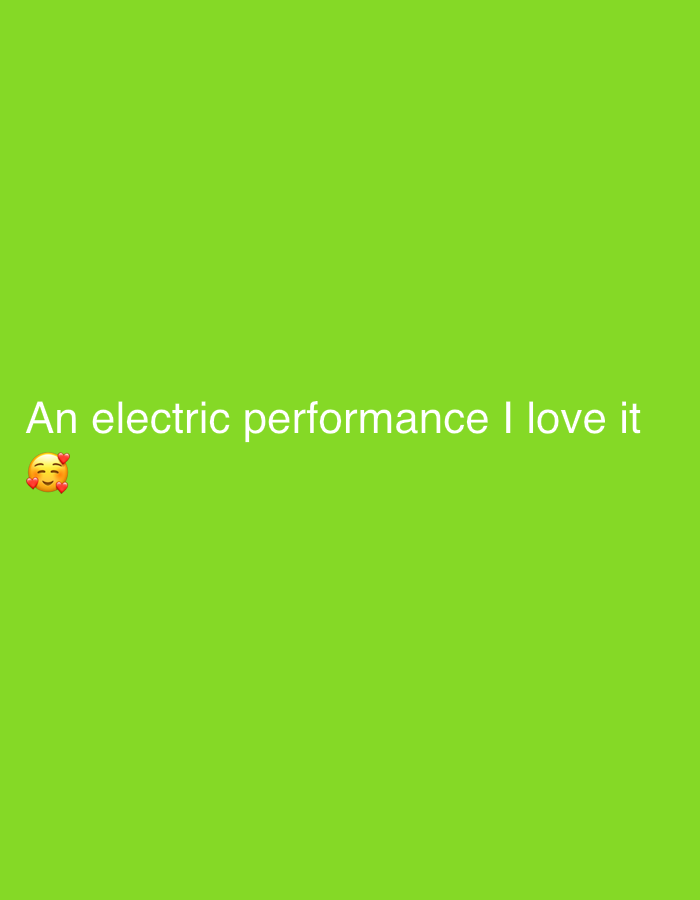 The image is a screenshot from a mobile device with a solid bright green background. White text is overlaid on the lower portion of the screen, reading "An electric performance I love it". To the left of the text is a smiling face emoji surrounded by small red hearts. There is no indication of the city of Jalingo, Nigeria in the image.