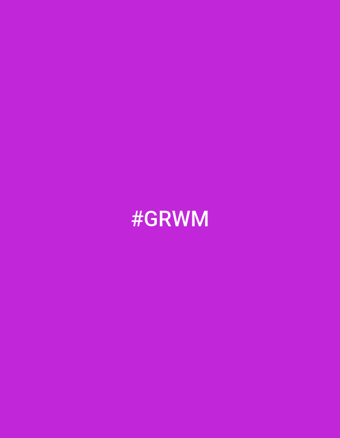 The image displays a solid, vibrant purple background. Centered on the background is the hashtag "#GRWM" in white text. The hashtag stands for "Get Ready With Me." There are no people, objects, or environmental details present in the image.
