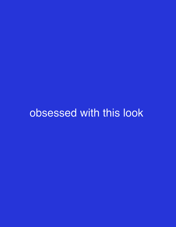 The media file is a static image with a plain, solid royal blue background. Centered within the image, in white, sans-serif text, is the phrase "obsessed with this look". There are no people, objects, scenes, or specific settings depicted. The image does not suggest a particular time of day, weather, or location, other than the provided context of Dubai, United Arab Emirates. No activity or event is taking place. The only discernible elements are the text and the background color.