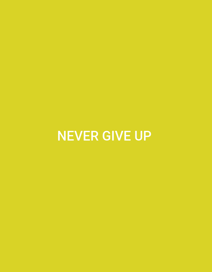 The image is a digital graphic with a plain, bright yellow background. Centered on the background is the text "NEVER GIVE UP" in white, sans-serif font. The text is legible and appears to be a motivational message. There are no other objects, people, or discernible environmental details in the image. It is not possible to determine the location in the city of Unknown, Unknown as there are no contextual clues.
