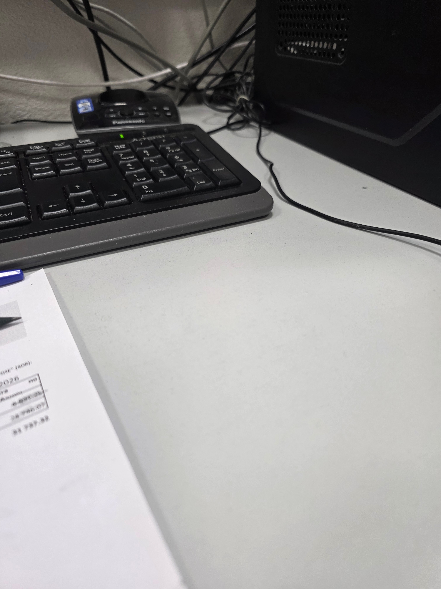 The image displays a desk with a keyboard and a document. A black computer tower is visible on the right side of the image. The document on the left has some text and numbers, with one line reading "2026" and another line showing "$1,737.32". A blue pen is also partially visible on the document. The overall scene appears to be an office or study environment. There is no information available about the location in Stavropol, Russia.
