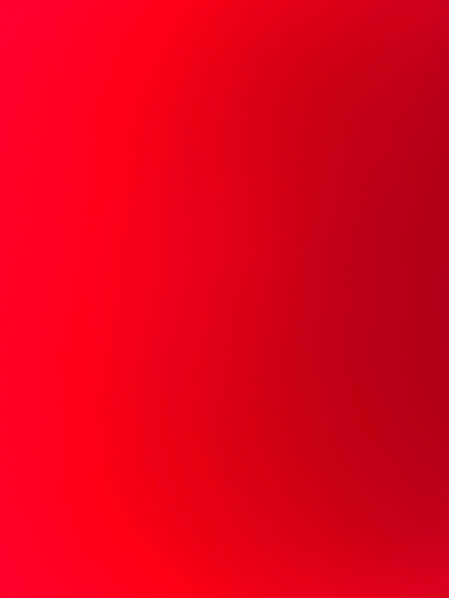 The image is a solid red gradient. The color is deepest red at the bottom right corner and fades to a lighter, brighter red towards the top left corner. There are no objects, people, or discernible environmental features visible in the image. Therefore, it is not possible to determine the location within Safari, Nigeria or any details about a scene.
