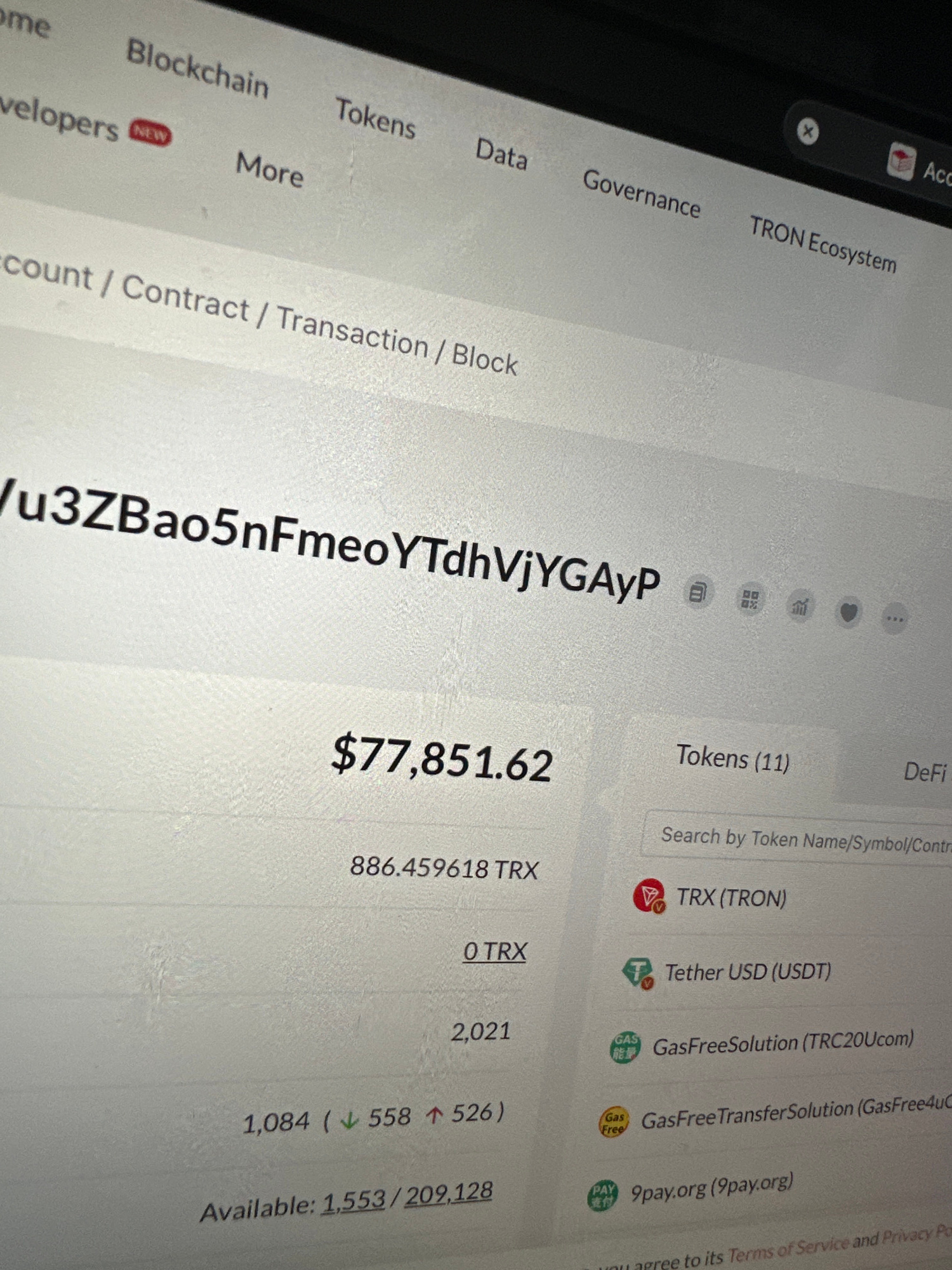 The image displays a computer screen showing a cryptocurrency wallet or explorer interface. The screen exhibits a balance of $77,851.62, with a breakdown of 886.459618 TRX and other token information. The context appears to be related to the TRON blockchain ecosystem, with entries for TRX (TRON), Tether USD (USDT), GasFreeSolution, GasFreeTransferSolution, and 9pay.org. Navigation elements like "Blockchain," "Tokens," "Data," and "Governance" are visible at the top. The display is likely from a desktop or laptop computer. There is no information in the image that indicates the location of Tyumen, Russia, or any people.