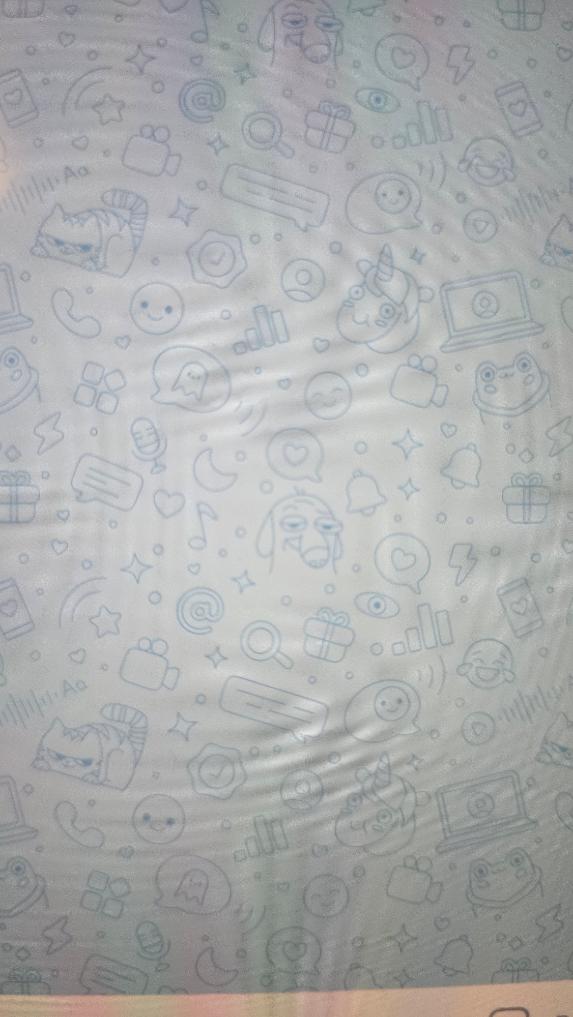 The image shows a light blue textured background covered in a repeating pattern of light blue line drawings of various icons. These icons include smiling faces, a cat, a dog, a unicorn, a frog, a laptop, a camera, a phone, a microphone, a gift box, a heart, a star, a moon, an email symbol, a speech bubble with a ghost, a lightning bolt, a play button, a waveform, a magnifying glass, a checkmark, and a bell. There are no people or recognizable landmarks visible. The image is a digital wallpaper or pattern and does not depict any specific location in Ukhta, Russia.