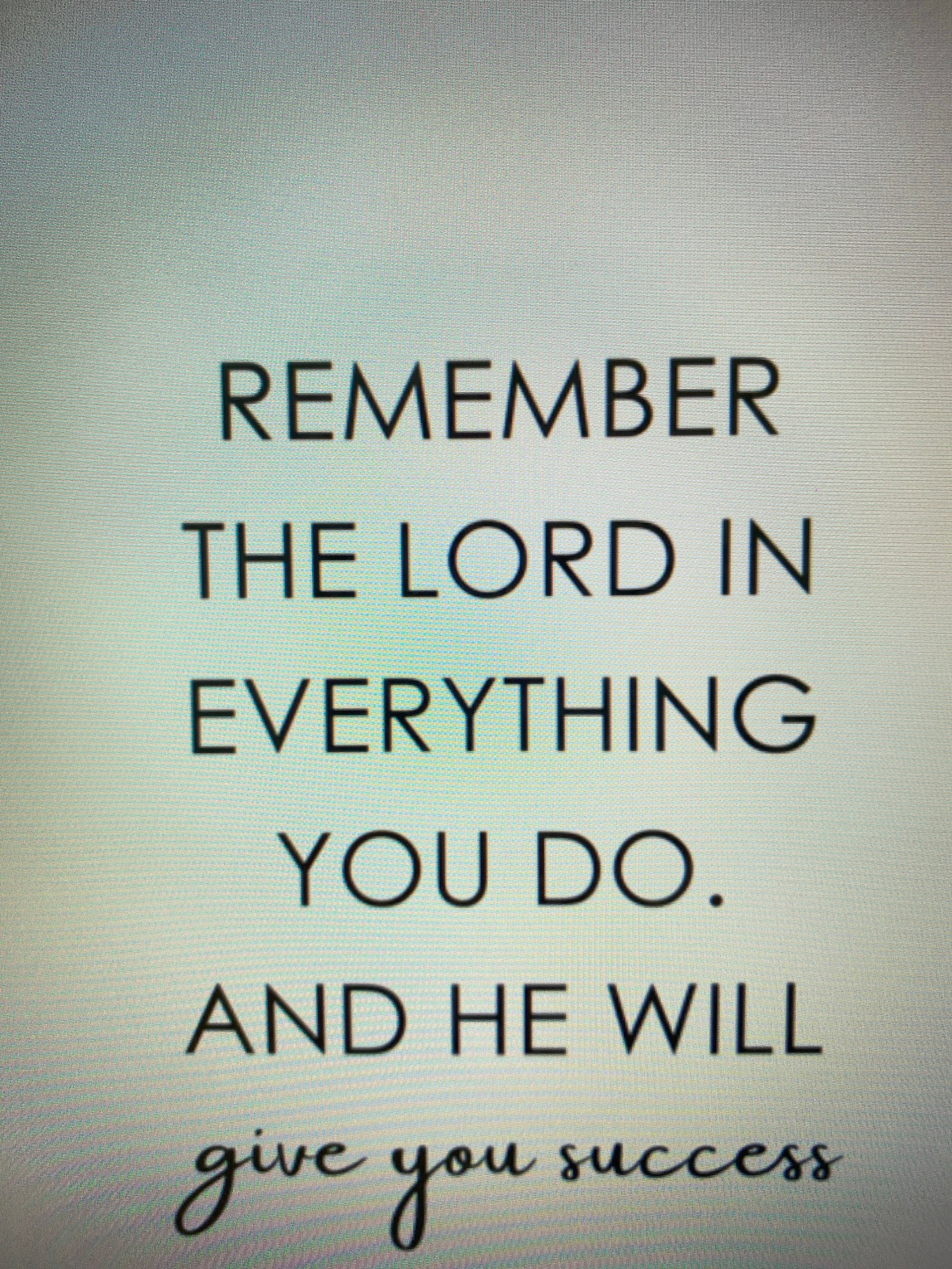 The image displays text on a screen with a subtle grid pattern, suggesting it's a photograph of a digital display. The text is arranged in multiple lines and reads: "REMEMBER THE LORD IN EVERYTHING YOU DO. AND HE WILL give you success". The first four lines are in a sans-serif font, while the last line, "give you success", is in a cursive font. There are no people, objects, actions, interactions, or environmental details related to the city of Chișinău, Moldova, present in the image.