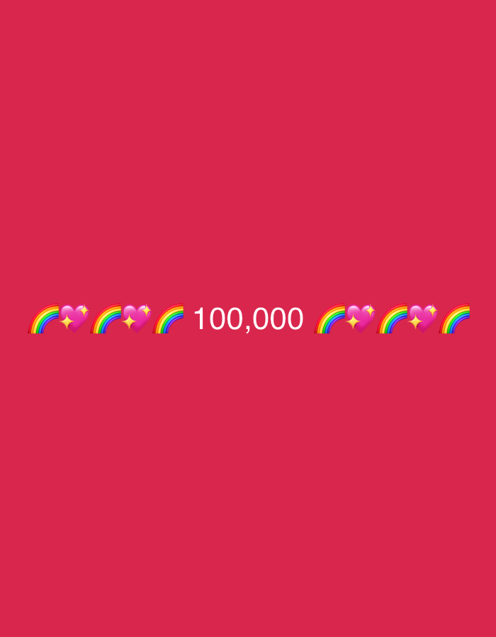 A celebratory graphic displays the number "100,000" in white text. This number is flanked by a series of rainbow and heart emojis on both sides. The background is a solid, vibrant pink. There are no people, objects, actions, or interactions depicted. The location in Tbilisi, Georgia cannot be determined from the image.