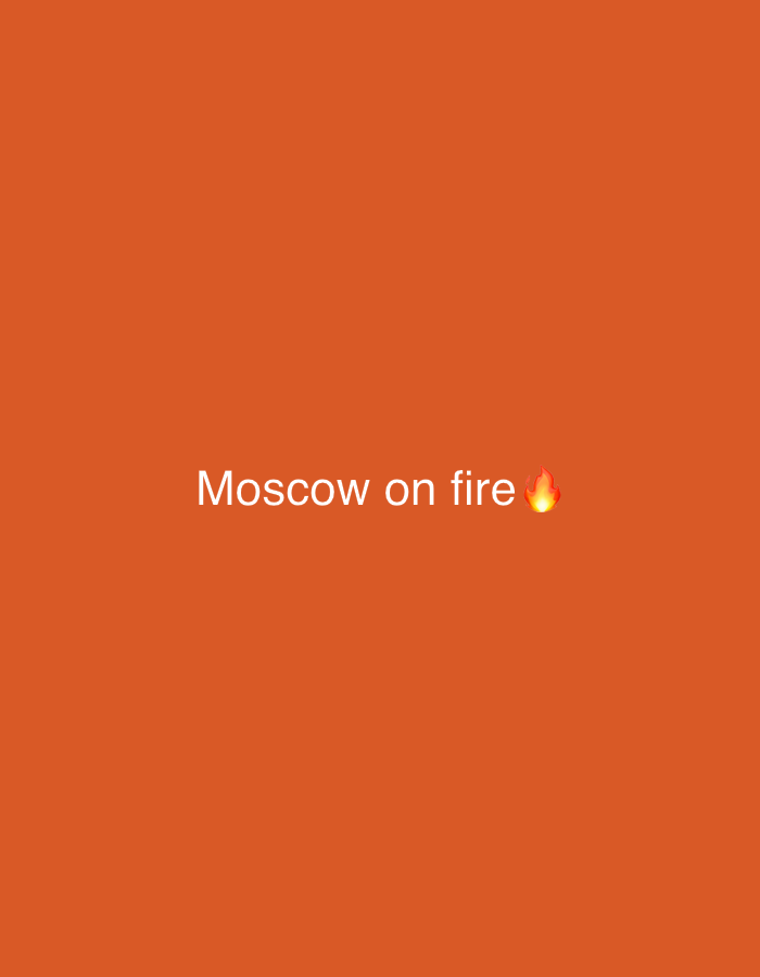 The media file is a simple graphic with a solid, bright orange background. Centered on the graphic is white text that reads "Moscow on fire". To the right of the text is an emoji of a flame, also in orange and yellow. The text and emoji appear to be a statement or a meme. There are no people, objects, or scene details visible in the image, other than the text and emoji. The overall impression is a digital graphic designed for social media or online sharing, likely conveying a sense of intensity or excitement, possibly in a figurative sense rather than a literal one. No specific time of day, weather, or location cues are present within the image itself, making it context-dependent for interpretation. The location context provided (Kaunas, Lithuania) is external to the visual content of the image and does not inform the description of the image itself.