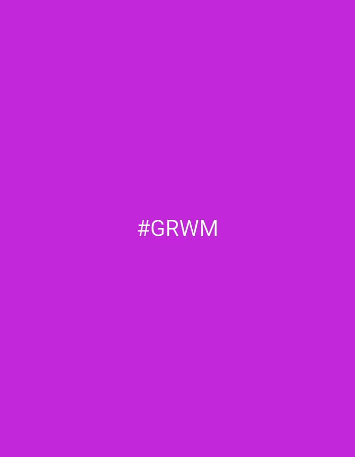 The image is a plain, solid purple background with white text in the center that reads "#GRWM". The purple color is a bright, vibrant shade, reminiscent of fuchsia or a strong magenta. The text "#GRWM" is capitalized and appears in a simple, sans-serif font, centered horizontally and vertically within the frame. The abbreviation "#GRWM" typically stands for "Get Ready With Me," commonly used in social media contexts to indicate a video or post detailing a person's preparation for an event, often involving makeup, fashion, or grooming. There are no discernible subjects, objects, scenes, or specific locations within the image; it is solely a colored background with text. The absence of any other visual elements makes it impossible to determine the time of day, weather, or specific location. Similarly, no emotions are conveyed by the image itself, other than potentially the energetic and bold association of the vibrant purple color.