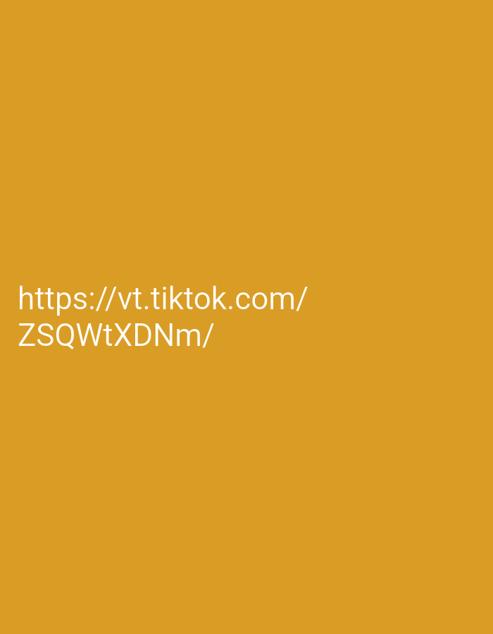 This is a digitally generated image with a solid mustard yellow background. White text is overlaid on the image, displaying a TikTok URL. The text reads "https://vt.tiktok.com/" on the first line and "ZSQWtXDNm/" on the second line. The image is not a photograph and therefore has no location, people, subjects, objects, actions, interactions, or environmental details.