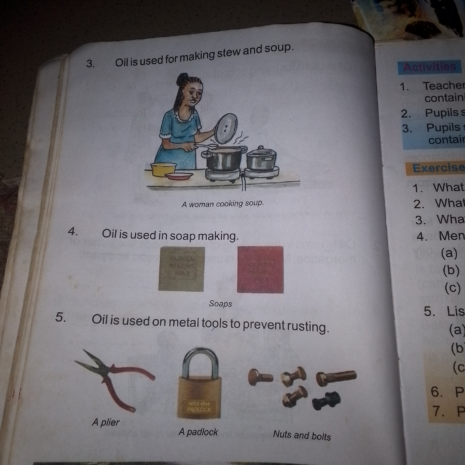 The image displays an open book with text and illustrations. On the left page, numbered points describe uses of oil. Point 3 states "Oil is used for making stew and soup," accompanied by an illustration of a woman cooking. Point 4 says "Oil is used in soap making," showing two square blocks labeled "Soaps." Point 5 states "Oil is used on metal tools to prevent rusting," with images of pliers, a padlock, and nuts and bolts. The right page has sections titled "Activities" and "Exercise," listing numbered questions and sub-questions. The image does not contain any information related to the city of Jauro Yinu, Nigeria.